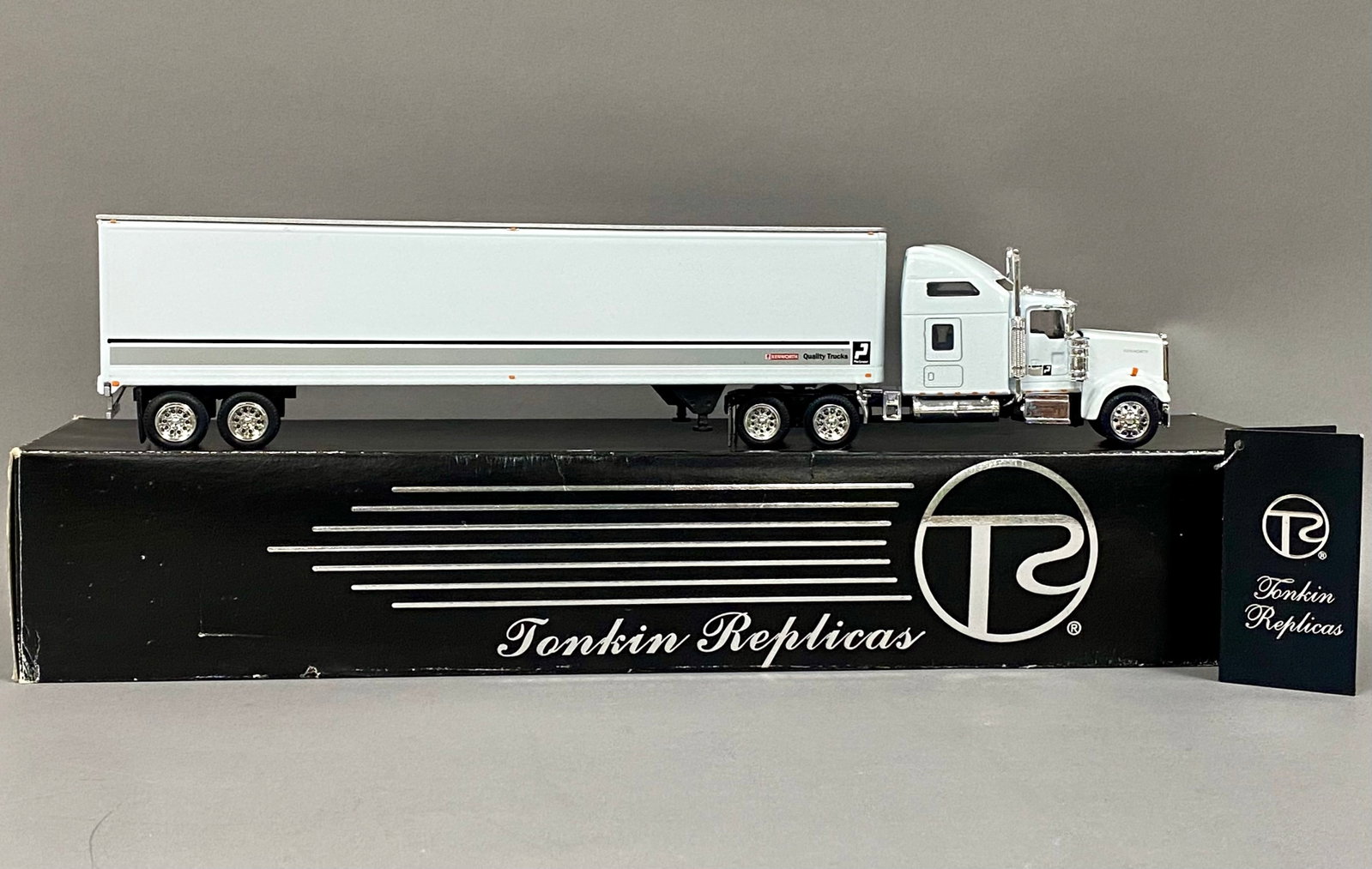 Tonkin Replicas 1/53 Scale Kenworth W900 Semi-Truck: This is a Tonkin Replicas 1/53 scale model featuring a Kenworth W900 tractor paired with a 48-foot van trailer. The model is constructed from die-cast metal with plastic detailing components. The set 