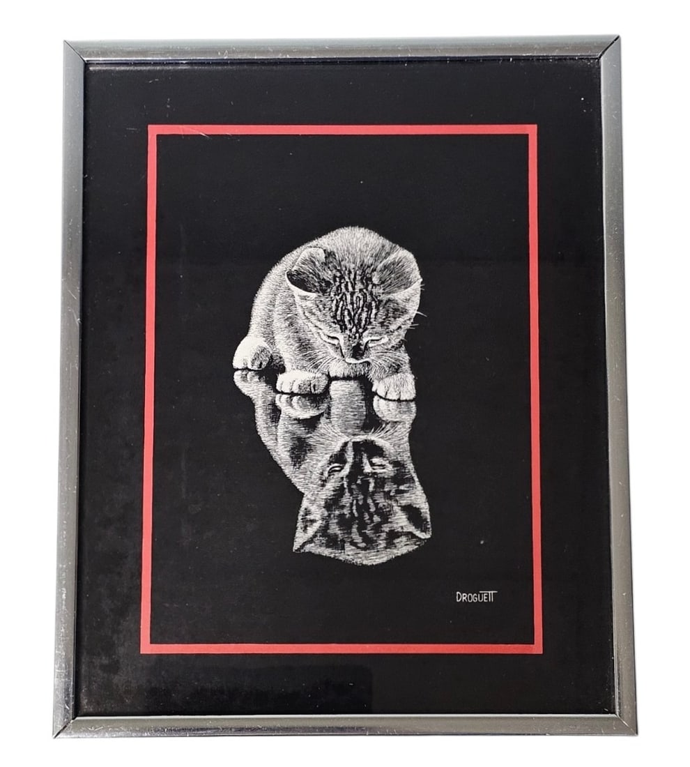 Vintage 1978 Droguett Kitten Artwork: This monochromatic framed artwork by Droguett depicts two kittens rendered in a scratchboard style. Produced by Figi Giftware in 1978, the piece is presented behind glass with a red-bordered black mat