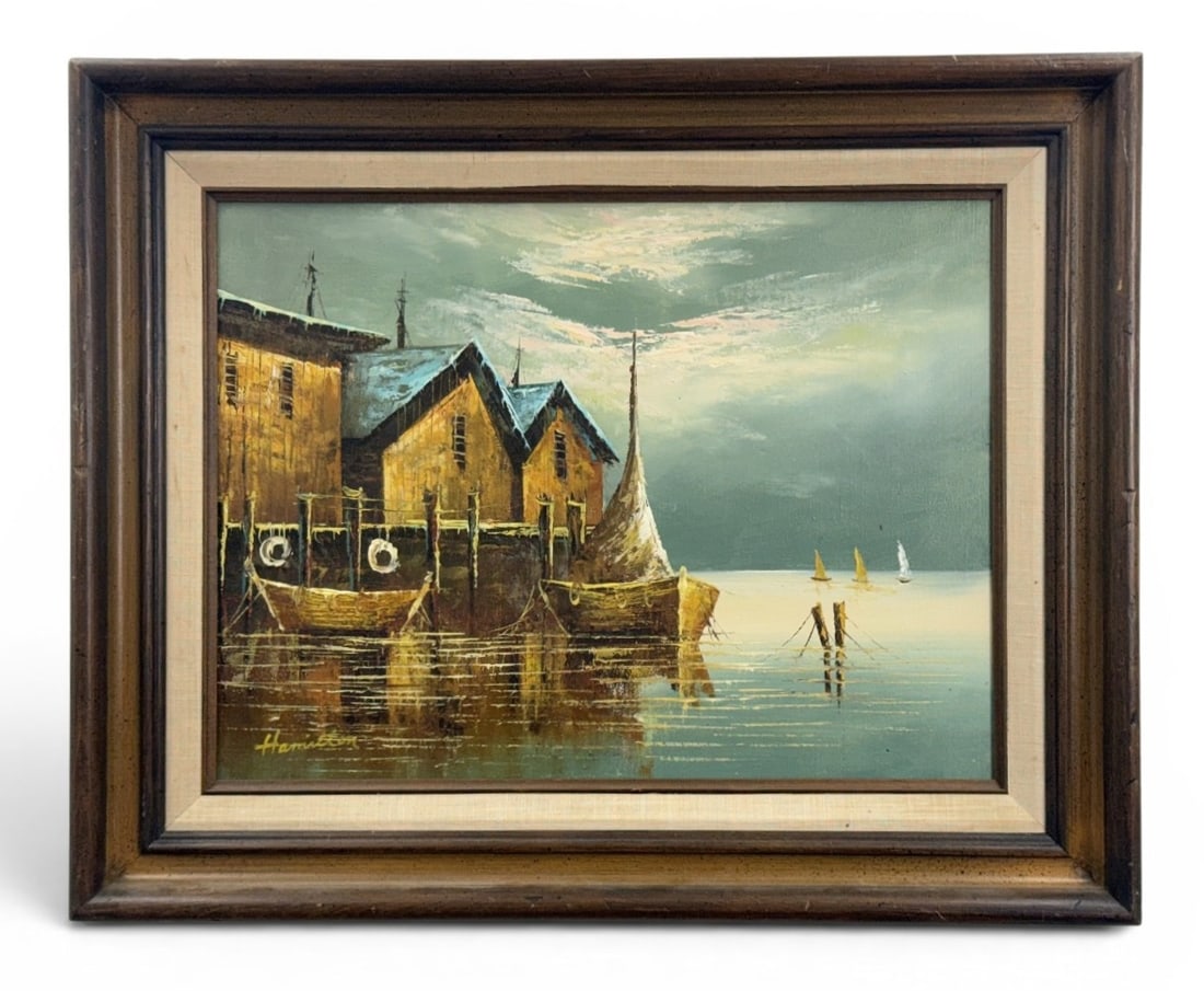 Mid-Century Harbor Scene Oil on Canvas Hamilton: This original oil on canvas painting depicts a nautical harbor scene with rustic waterfront structures on stilts and docked boats. The work is executed in an impressionistic style with heavy impasto a