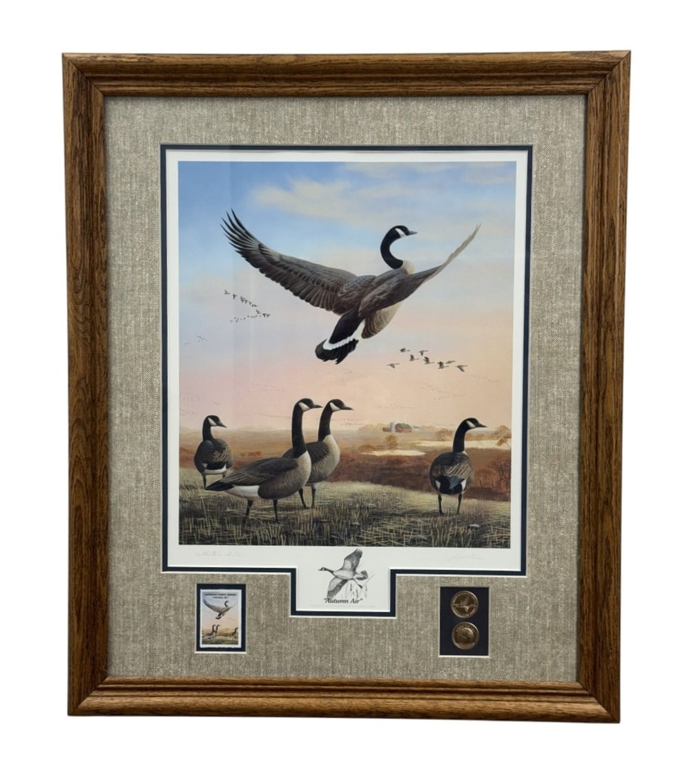 Leo Stans Autumn Air Signed Print: This framed limited edition offset lithograph by Leo Stans, titled Autumn Air and dated 1991, depicts Canada geese in a rural landscape. The work is hand-signed in pencil and includes a central
