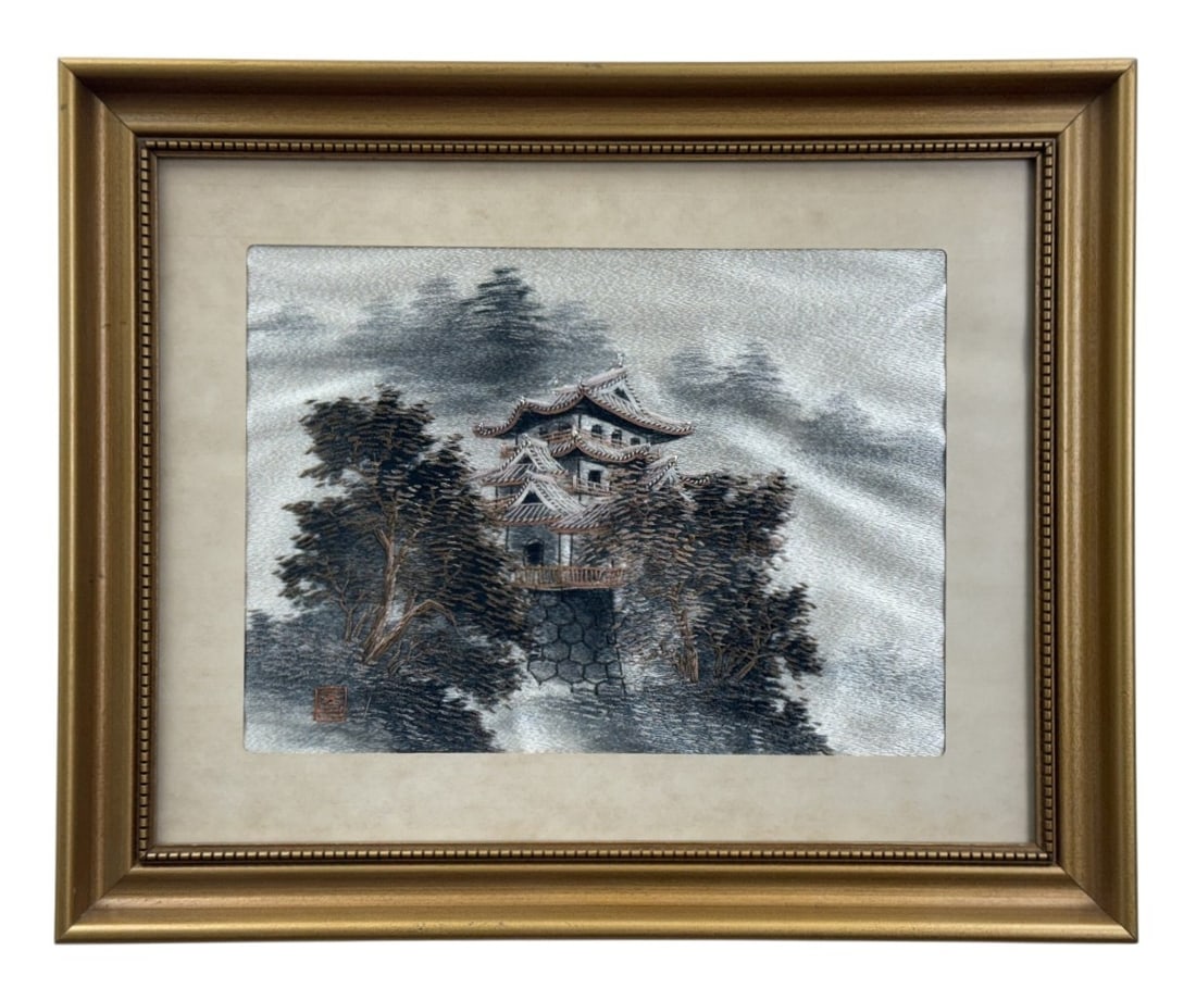 Framed Japanese Silk Landscape Embroidery: This mid-century Japanese silk embroidery depicts a traditional castle tower set within a misty mountainous landscape. The work is executed using varied thread thicknesses on a silk ground and include