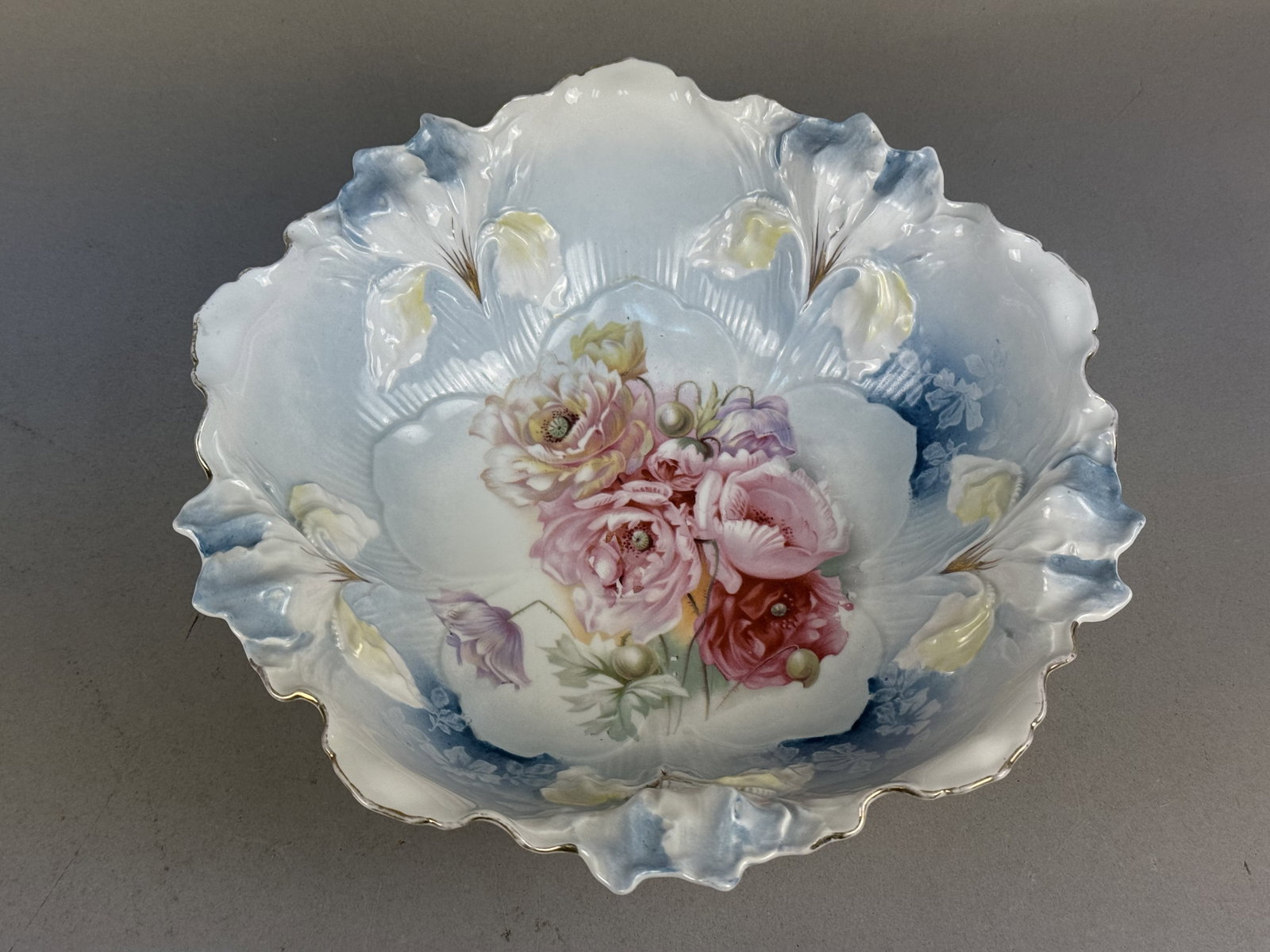 R.S. Prussia Floral Porcelain Bowl: A fine R.S. Prussia porcelain serving bowl featuring a deeply lobed form with molded iris relief decoration. The interior displays a bouquet of pink, red, and yellow poppies surrounded by blown-out