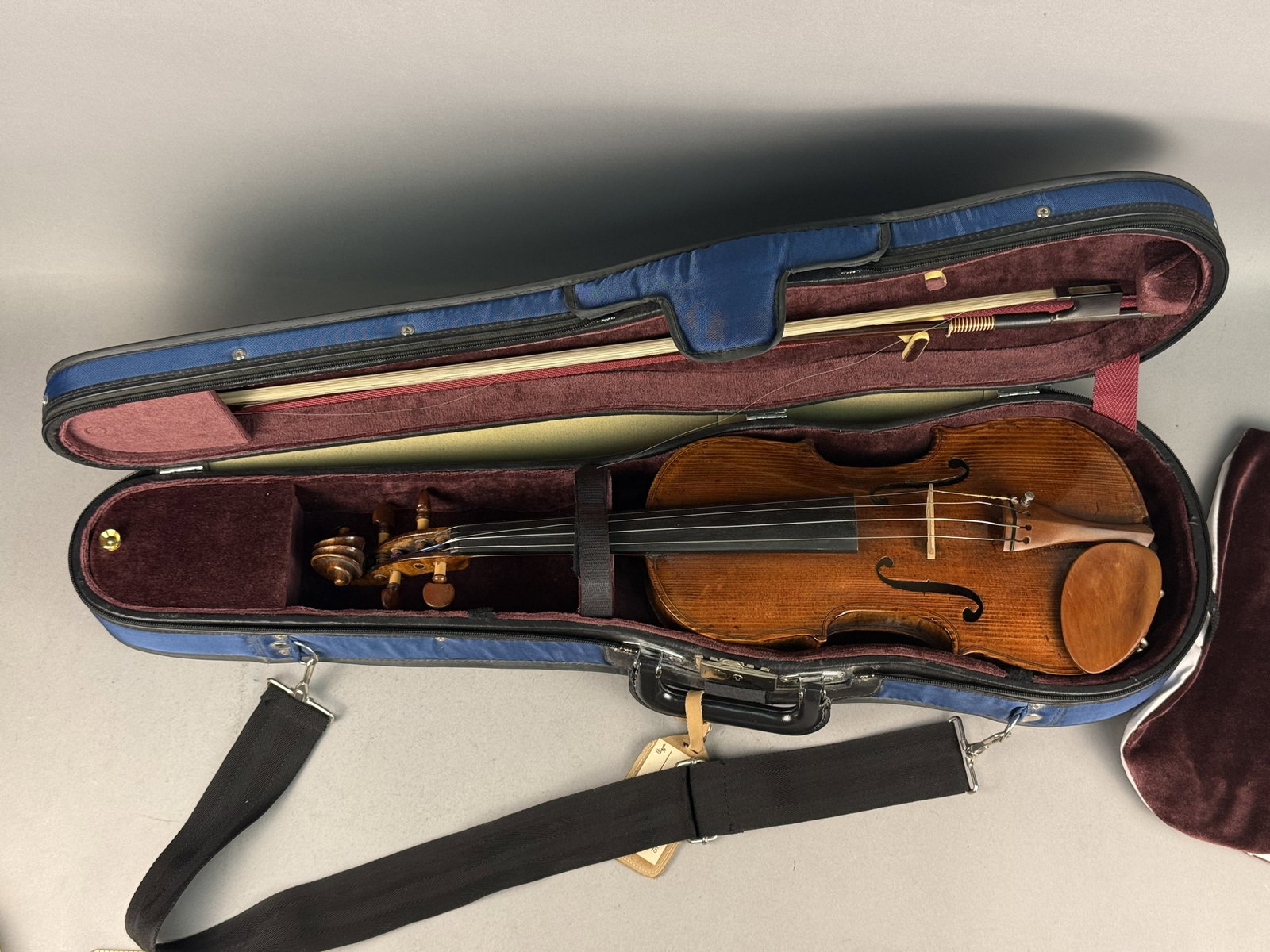 Full-Size Stradivarius Model Violin Outfit: This full-size violin features a highly flamed two-piece maple back and matching ribs paired with a fine-grained spruce top. The instrument is fitted with boxwood pegs, tailpiece, and chinrest, and it