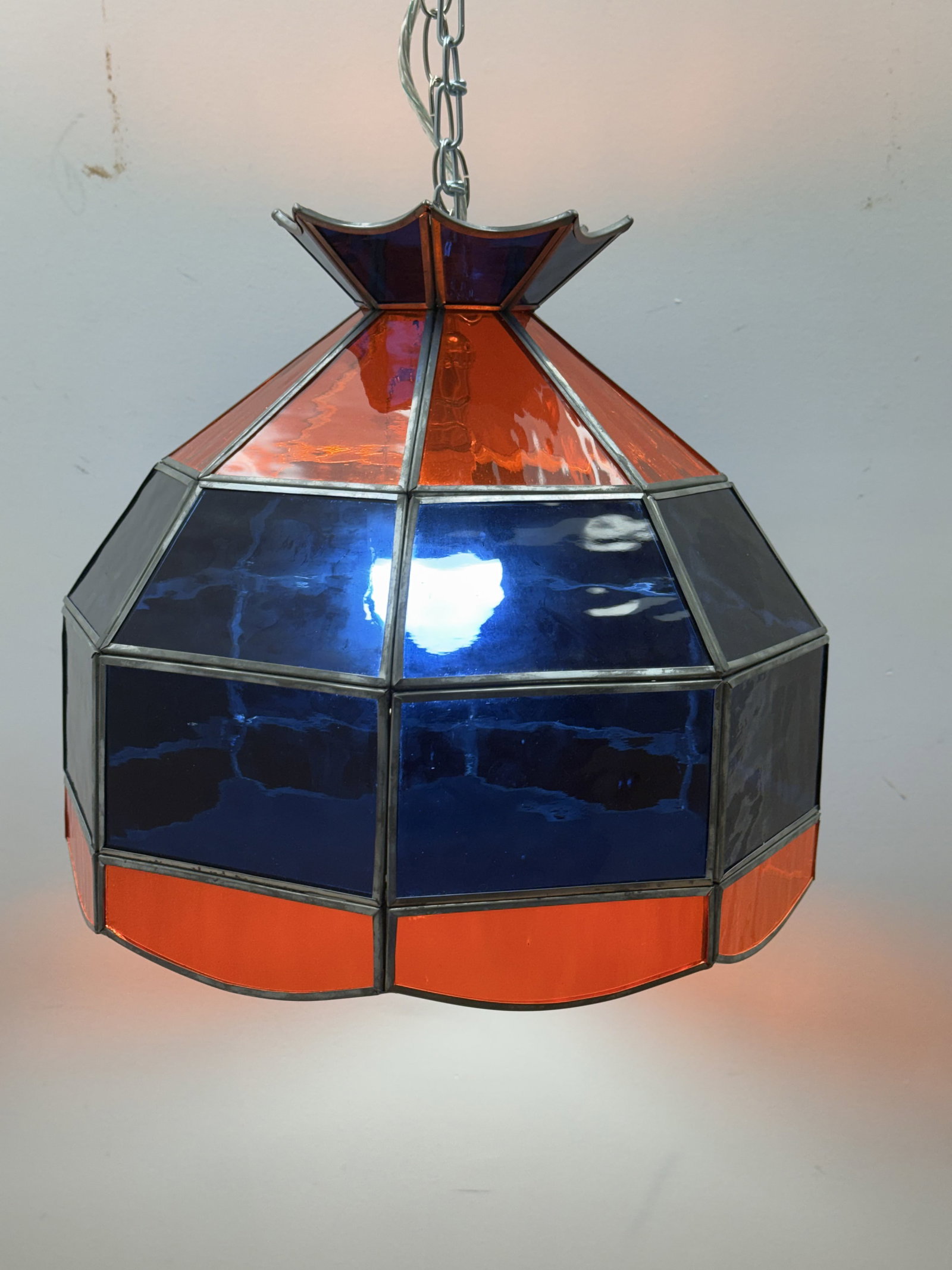 Virginia Cavaliers Stained Glass Swag Lamp: This octagonal leaded glass swag pendant lamp features a tiered design with cobalt blue and translucent orange panels consistent with University of Virginia branding. The faceted shade is constructed