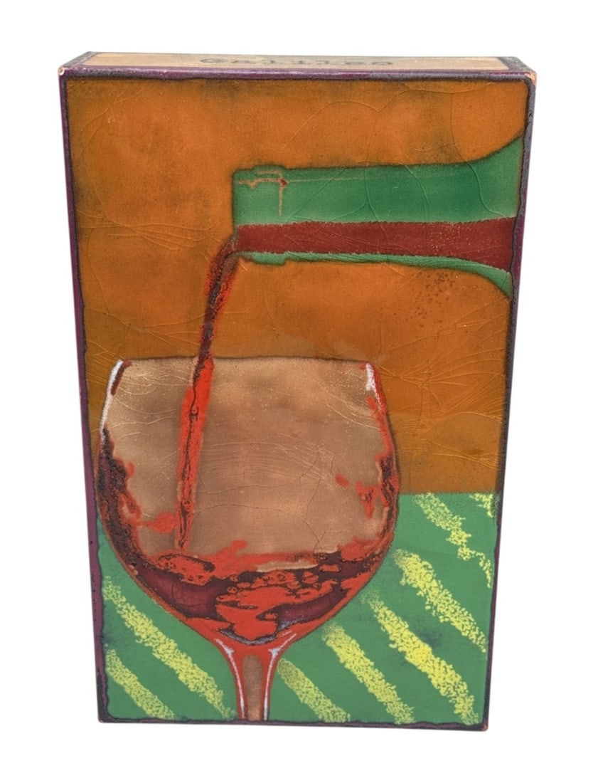Houston Llew Liquid Sunshine Spiritile: This contemporary Liquid Sunshine Spiritile by Houston Llew is handcrafted using a glass on copper enameling technique over a rectangular base. The design depicts red wine pouring into a glass against