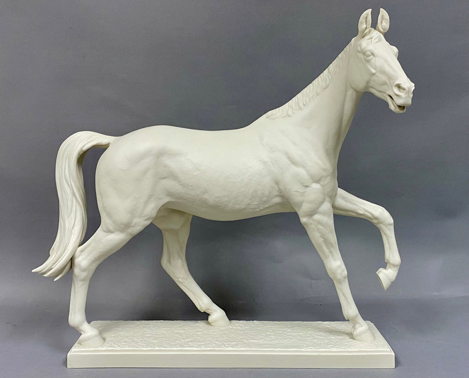 Hutschenreuther Bisque Porcelain Horse Figurine of Halla by Gunther Granget: A large bisque porcelain sculpture of the show jumping mare Halla, designed by Gunther Granget for the Hutschenreuther Kunstabteilung. The figurine depicts the horse in a trotting gait with the front 