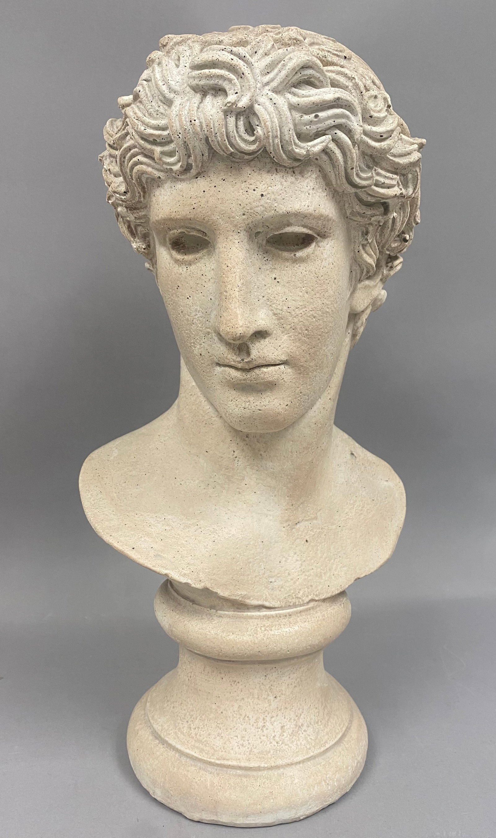 Austin Productions, Neoclassical Style Cast Stone Bust, 1984: A 1984 cast stone bust by Austin Productions, Inc., modeled in the Neoclassical style. The sculpture depicts a classical youth, often identified in the manufacturer catalog as Head of Athlete, with id