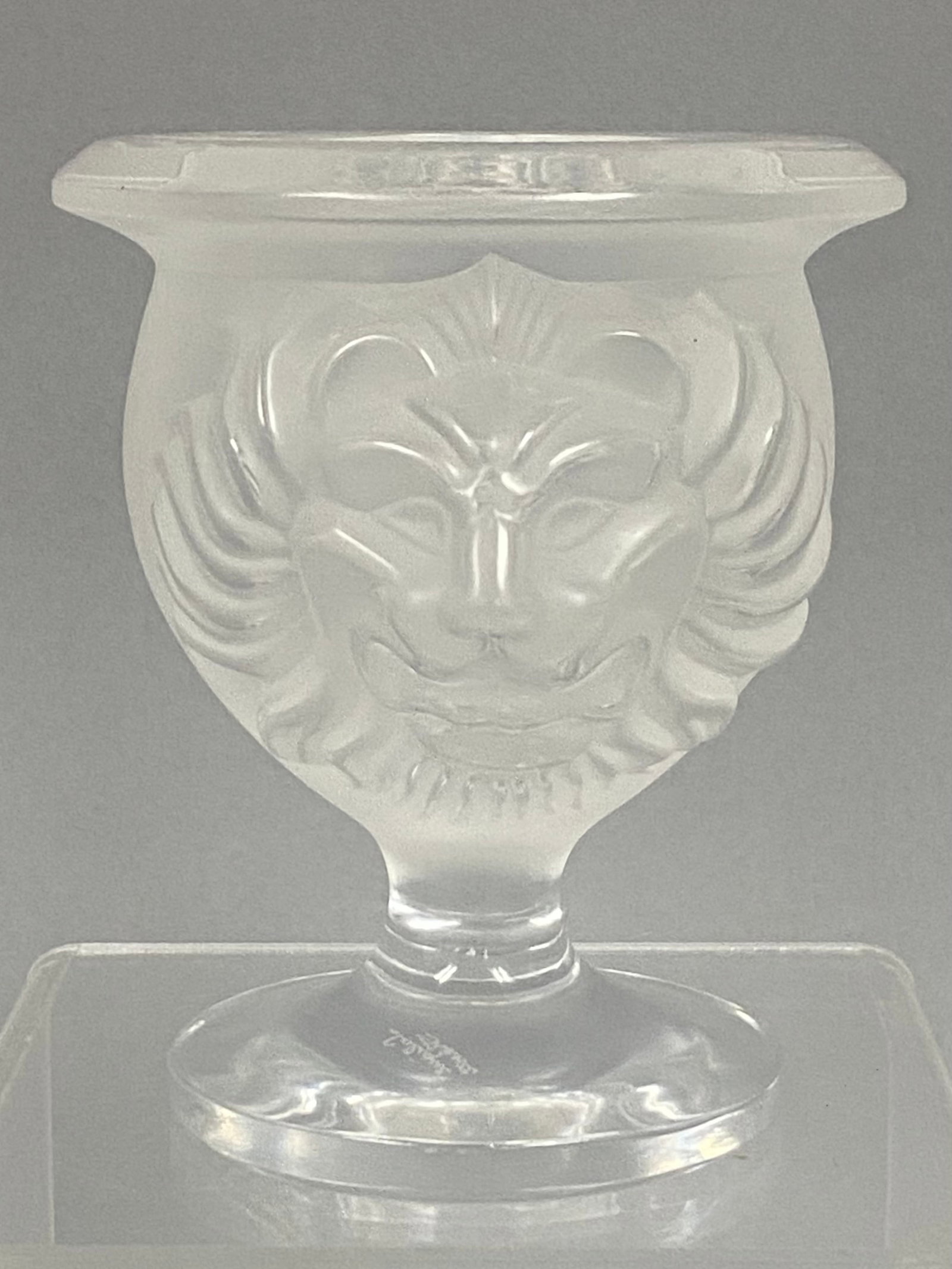 Lalique Tete De Lion Frosted Crystal Vase: A Lalique frosted and clear crystal vessel featuring the Tete de Lion (Lion Head) design. This small, footed vase or toothpick holder is constructed in a campana shape with a wide, flat flared rim.