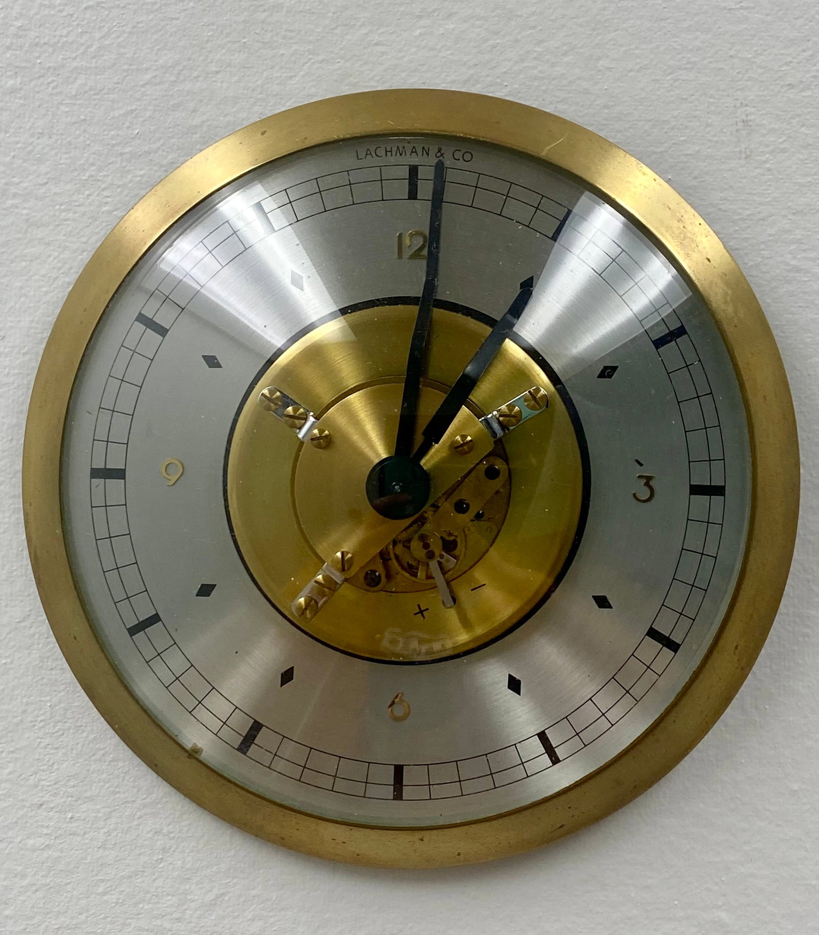 Mid Century German Lachman & Co Mechanical Clock: Vintage high quality mechanical desk clock signed Lachman & Co., featuring a German-made 8-day wind-up movement, brass bezel, brushed silver-tone dial, and visible balance wheel escapement. This