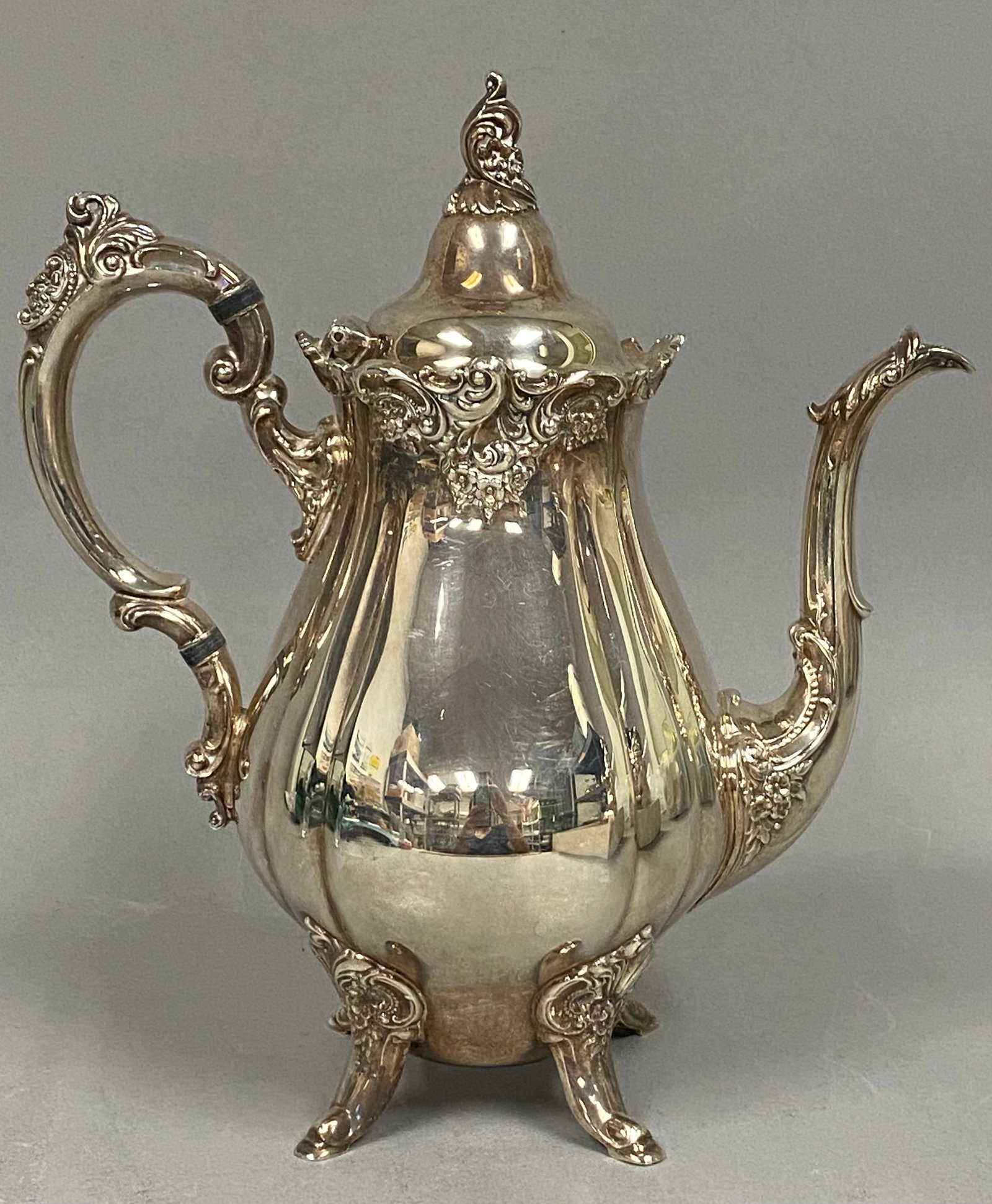 Wallace Baroque Silverplate Coffee Pot: A silver-plated coffee pot in the Baroque pattern by Wallace Silversmiths, model 282, featuring cast scrolled and floral decoration in the Rococo style. The vessel is designed with a high-domed