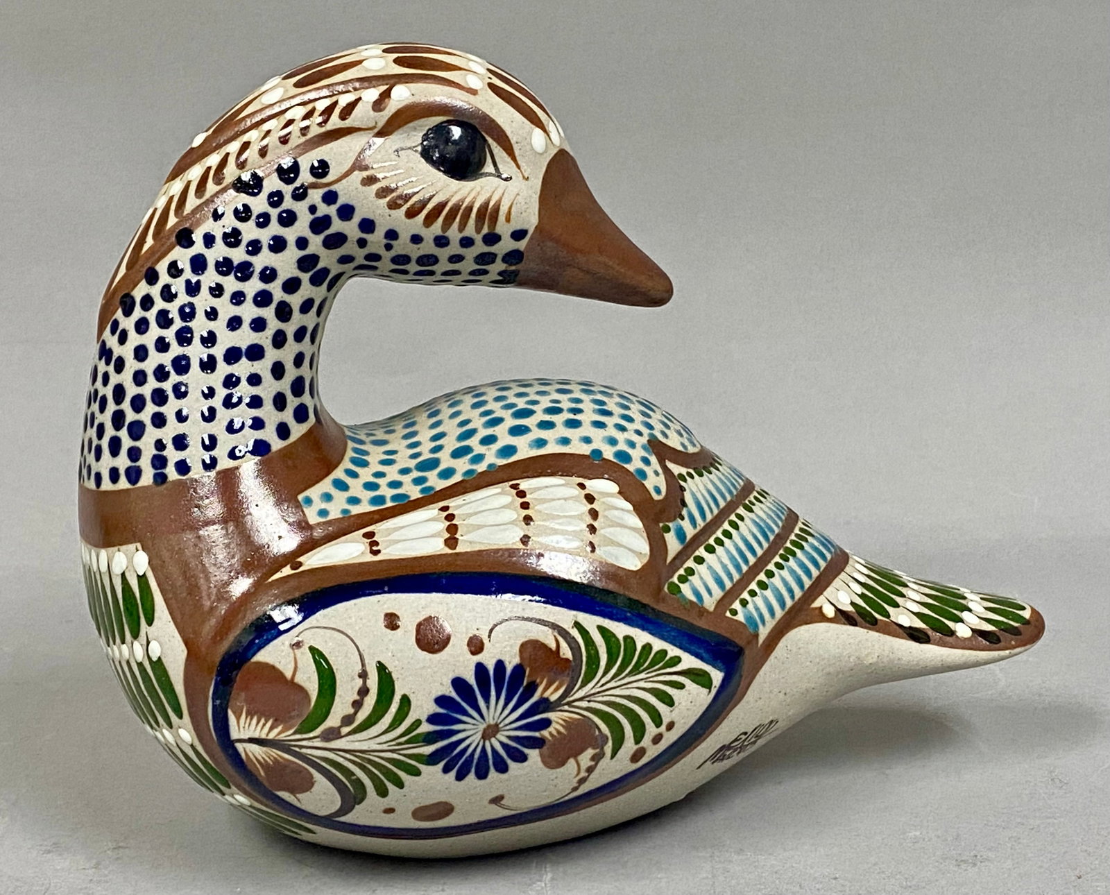 Tonala Ken Edwards Pottery Duck: This hand-painted stoneware duck figurine is crafted in the Tonala burnished tradition from Mexico. It features polychrome ornamentation with floral and geometric motifs in shades of blue, brown,