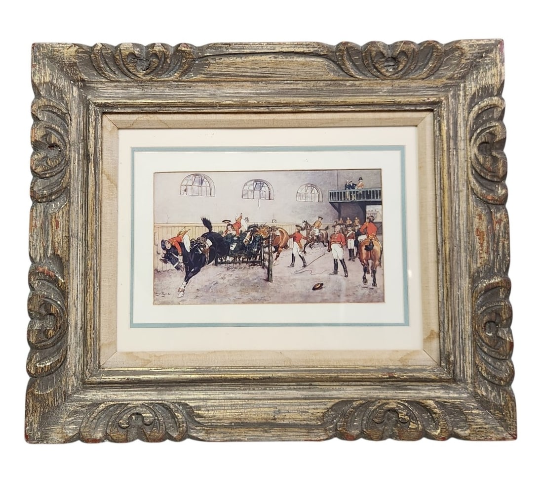 Harry Payne Military Equestrian Print: A framed print after Harry Payne depicting a military riding arena with soldiers in scarlet uniforms and horses. The work is housed in a large gilt-painted molded frame measuring approximately 24 by 2