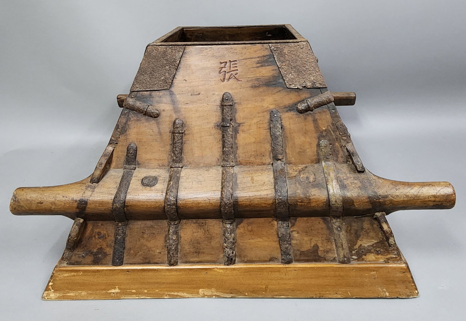 Antique Chinese Rice Measure: This antique tapered wooden grain measure features heavy iron strap reinforcement and four extended handles for transport. Each of the four upper faces displays an incised Chinese character including