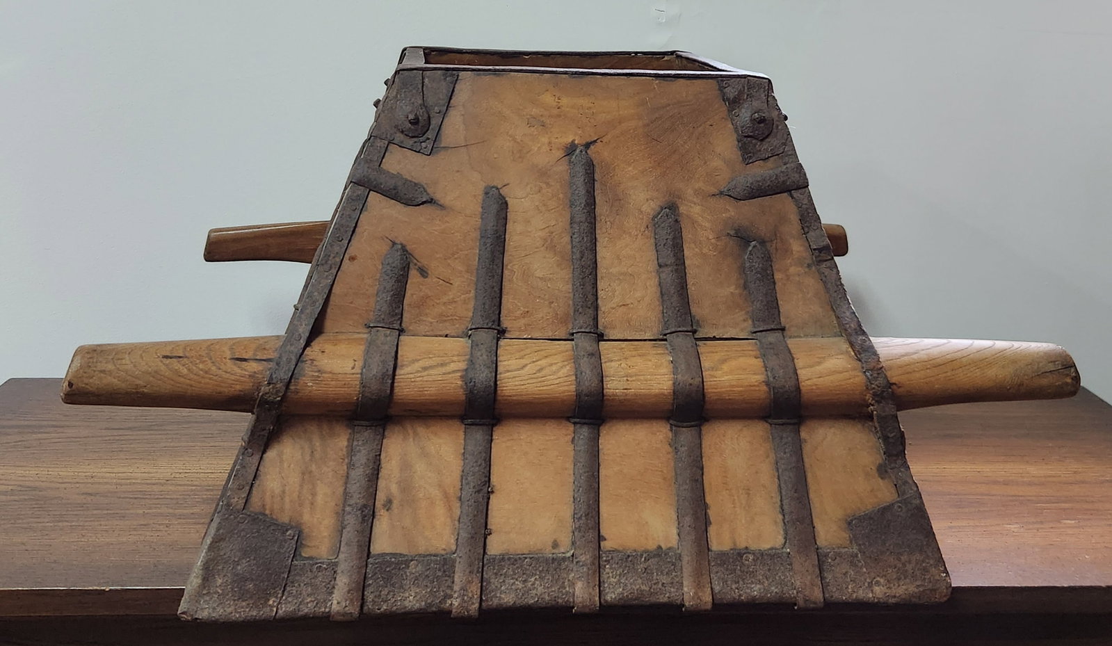 Antique Chinese Elmwood Rice Measure: An antique Chinese elmwood rice measure of tapered square form featuring hand-forged iron strapping and a lattice grid base. Height: approximately 16 inches Base width: 21.5 inches Top opening width: