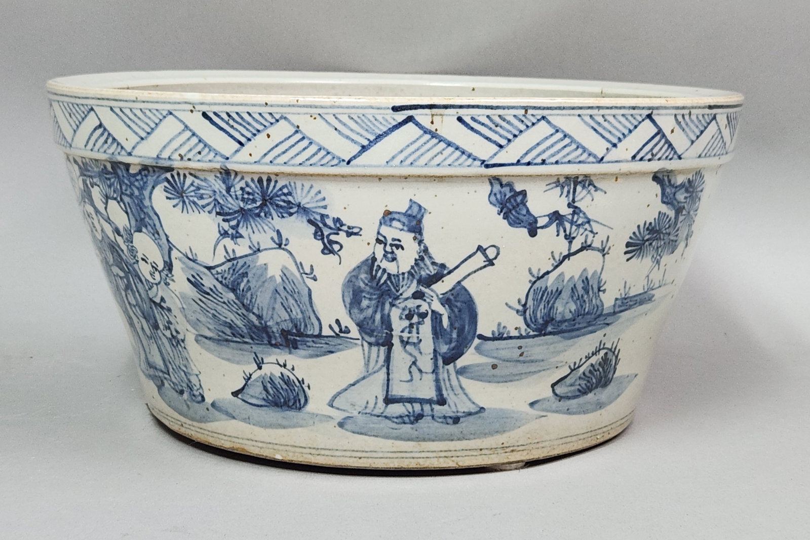 Chinese Porcelain Seven Sages Jardiniere: This large Chinese blue and white porcelain jardiniere is decorated with an underglaze narrative landscape depicting the Seven Sages of the Bamboo Grove. The exterior and interior glazes exhibit