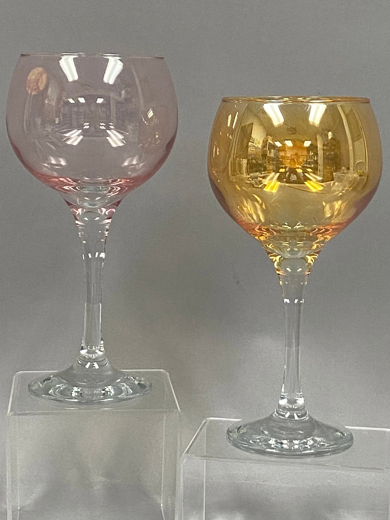 Pair of Crystal Clear Iridescent Glasses: This pair of contemporary balloon wine glasses features iridescent luster bowls and clear stems manufactured by Crystal Clear in TÄ‚Ä½rkiye. Each glass is designed with a large,