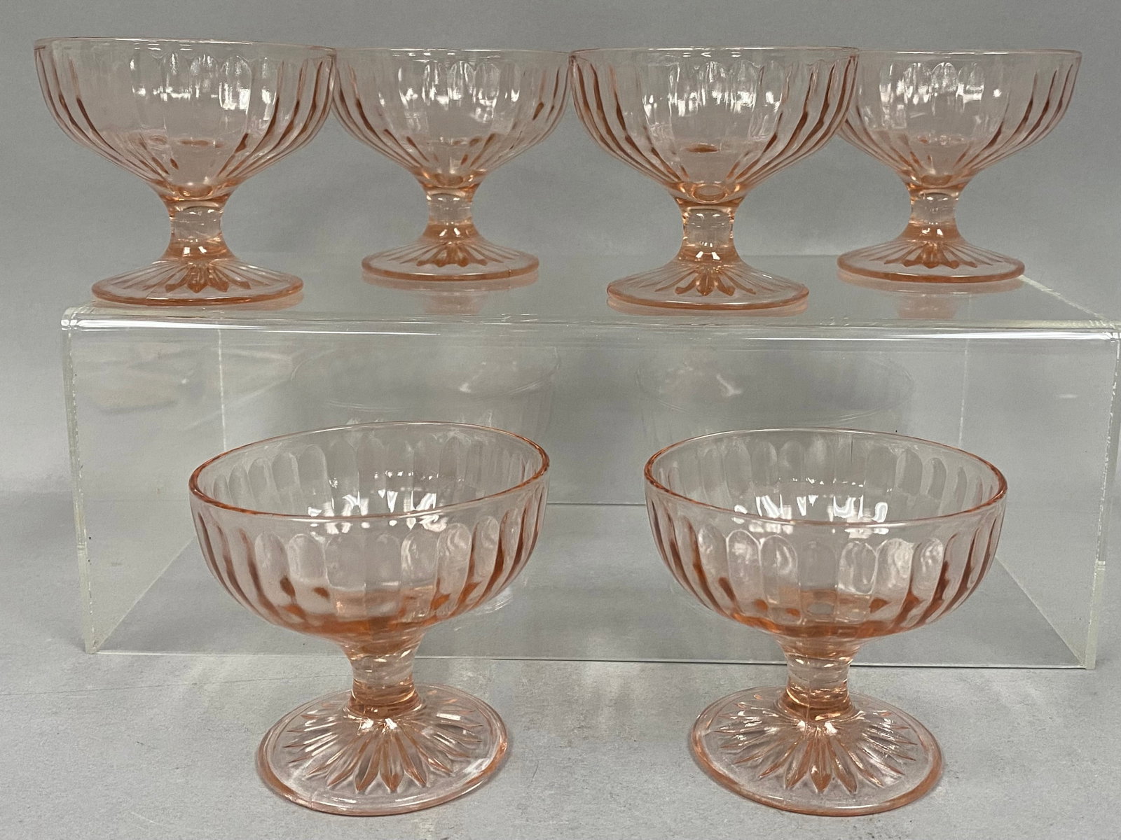 Set of Six Pink Block Optic Sherbets: A set of six Hocking Glass Company sherbet cups in the pink Block Optic pattern. Each piece features a wide pillar optic design terminating in arched tops and a short waisted stem. The circular feet