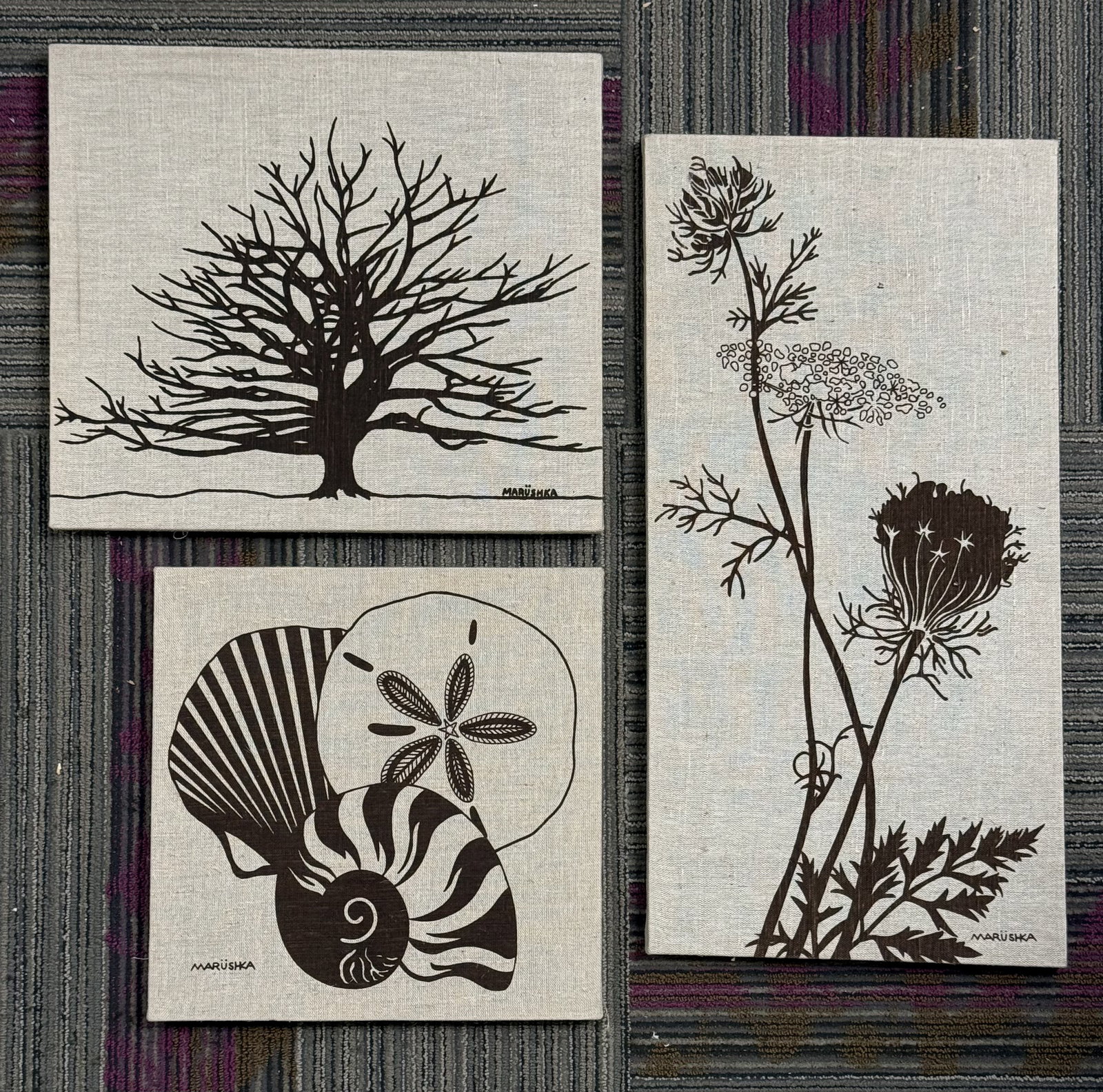 A Trio of Marushka Screened Linen Prints: This set of three hand-screened serigraphs by Marushka is executed in a single dark brown pigment on natural linen fabric. Each piece is gallery-wrapped over wooden stretcher bars and features