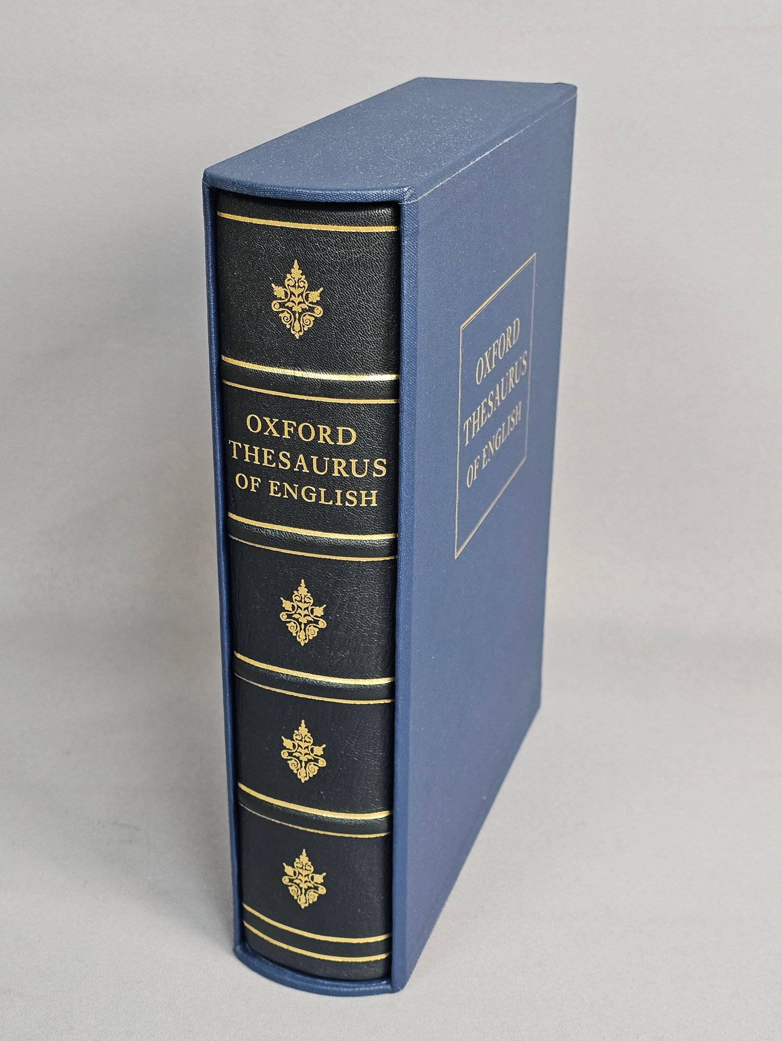 Folio Society Oxford Thesaurus 2004: This limited edition quarto is bound in three-quarter black Nigerian goatskin over blue moire silk boards by Smith Settle. The spine features four raised bands with gilt decoration, and the text