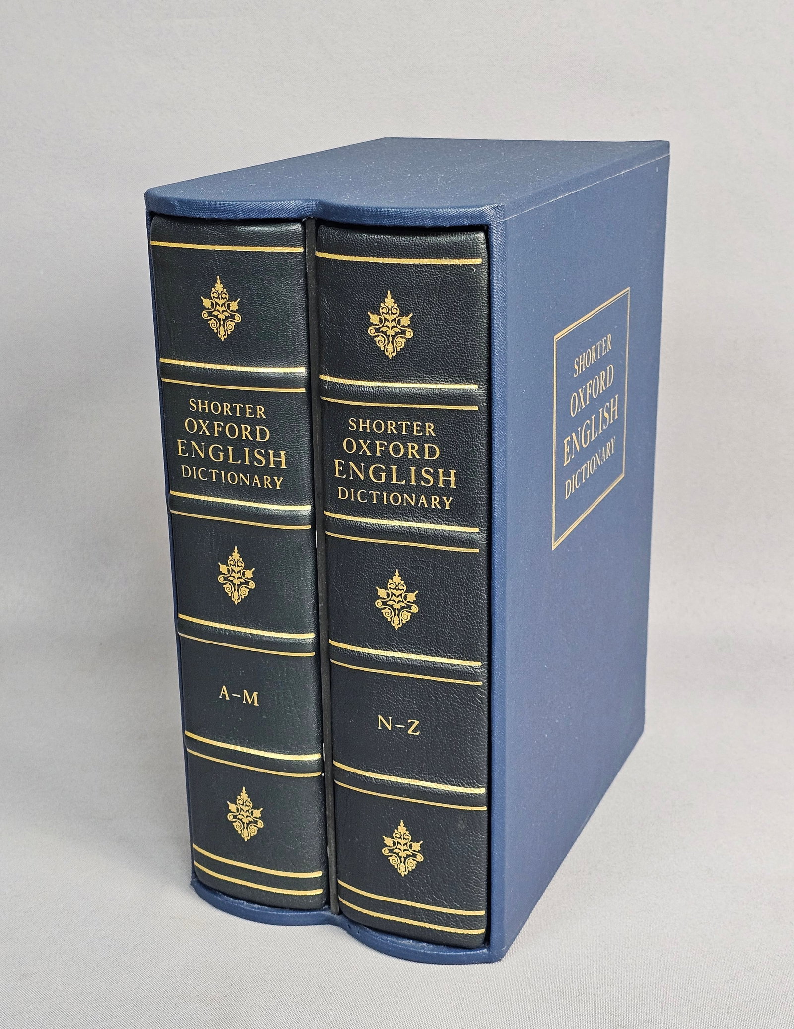 Folio Society Shorter Oxford English Dictionary Set: This two-volume fifth edition set is quarter-bound in navy blue Nigerian goatskin with moire silk sides and gilt-stamped spines. Bound by Smith Settle, the work is limited to 1,500 numbered copies,