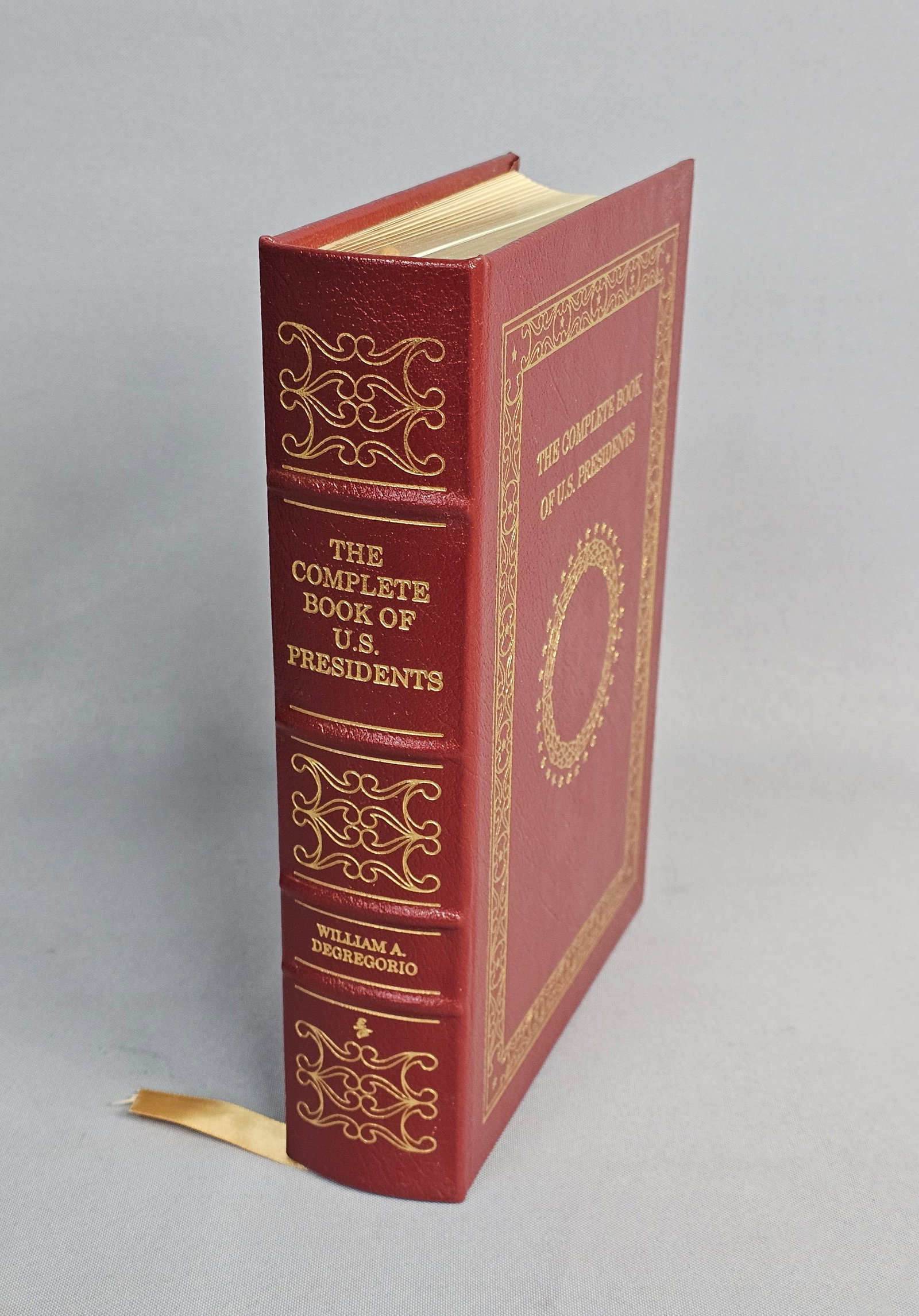 DeGregorio Complete Book of U.S. Presidents Easton 2006: This octavo volume by William A. DeGregorio is a special edition published by Easton Press in 2006. The work is bound in premium red leather with decorative 22kt gold-stamped designs on the front