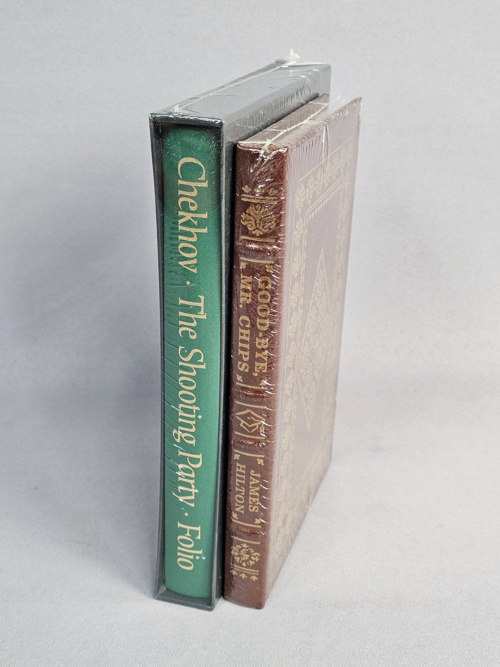Two Deluxe Edition Books Hilton and Chekhov: This collection includes James Hilton's "Good-bye, Mr. Chips" published by The Easton Press in gilt-decorated brown leather and Anton Chekhov's "The Shooting Party" by the Folio Society in green cloth