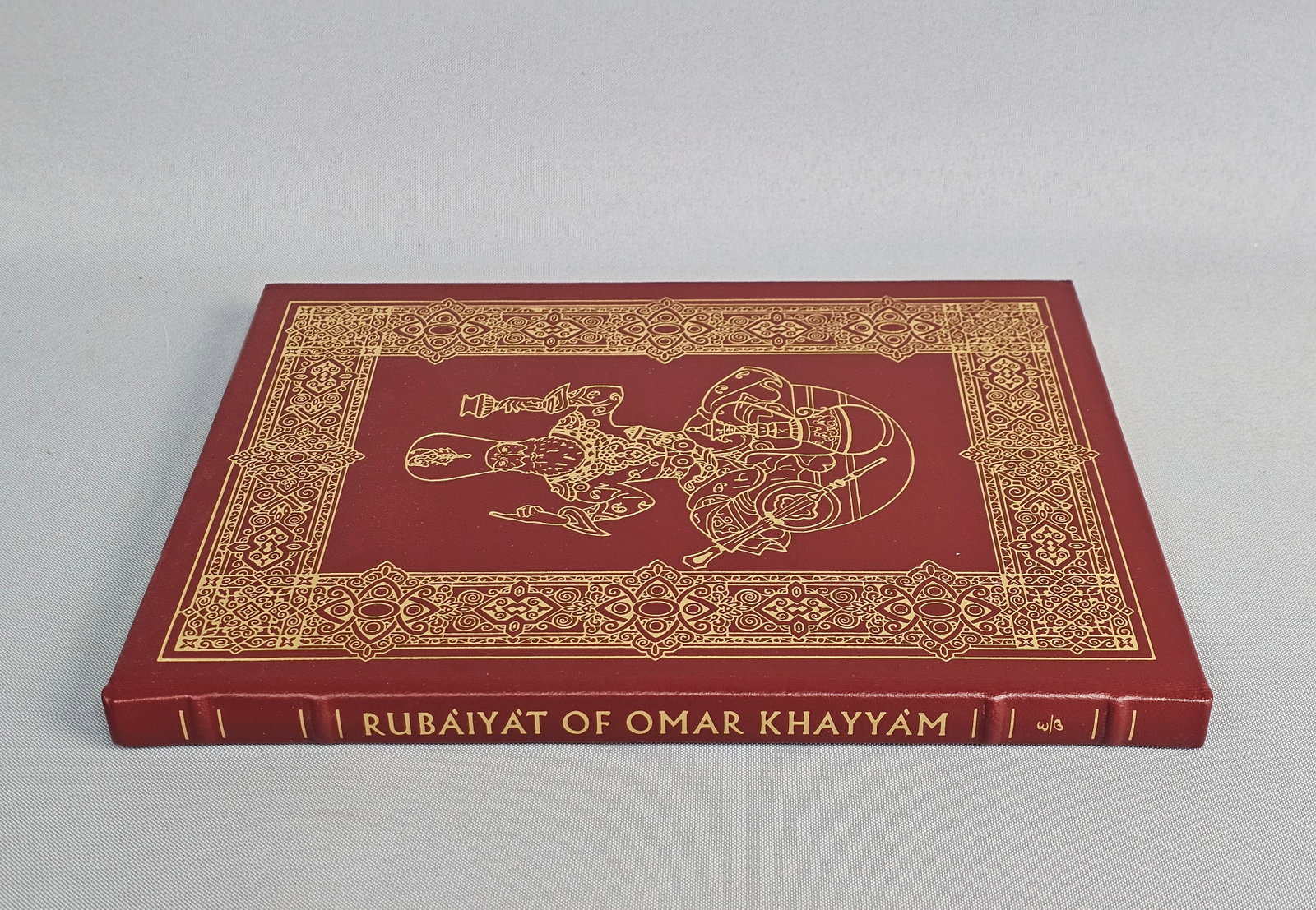 Rubaiyat of Omar Khayyam Collector's Book: This volume is bound in full crimson leather featuring elaborate 22kt gold gilt ornamentation on the boards and hubbed spine. The work includes color illustrations by Arthur Szyk, moire silk endpapers