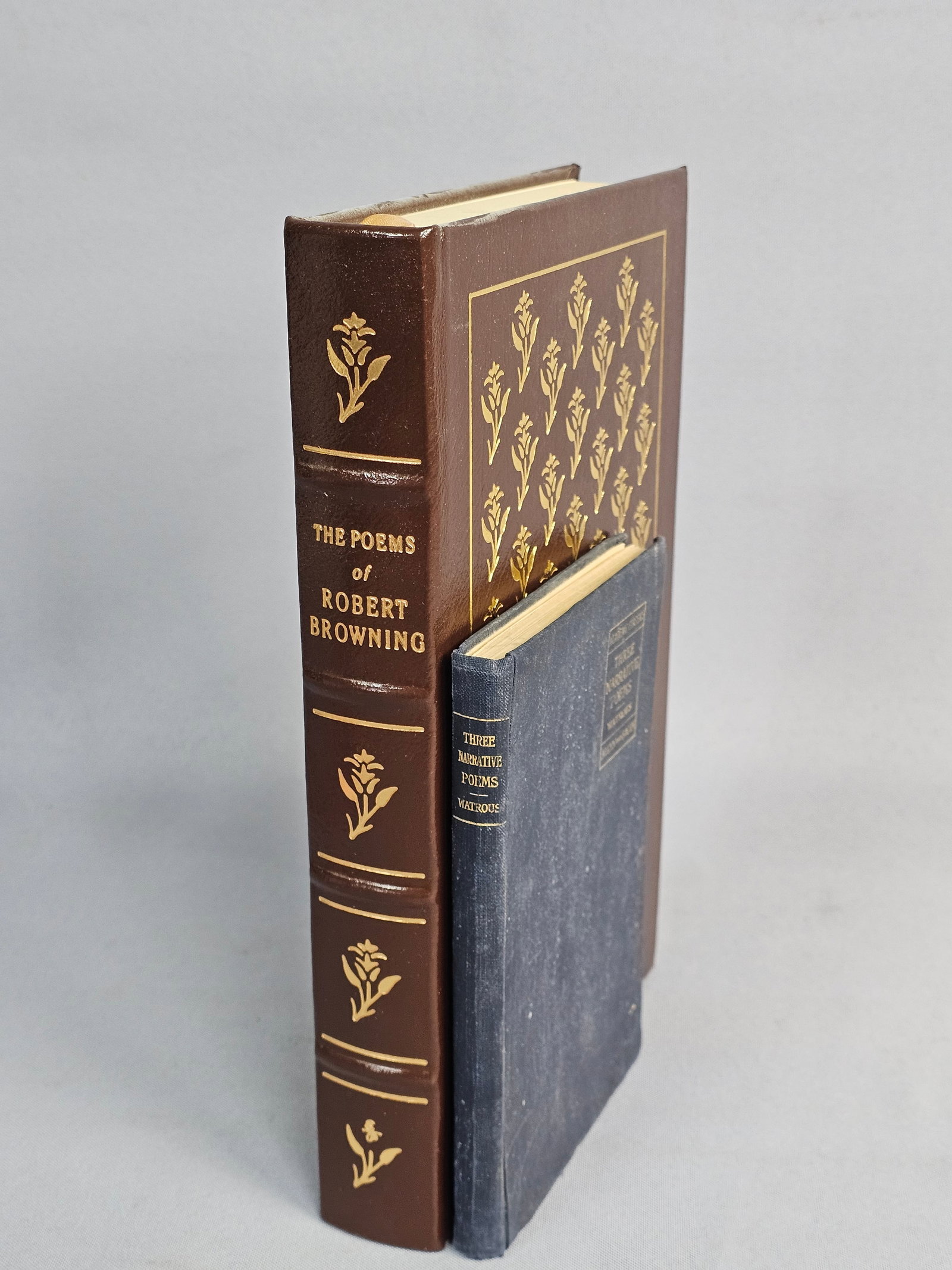 Two Volumes of Narrative Poetry: This lot features a 1979 Easton Press leather-bound edition of Robert Browning's poems and an 1898 Allyn and Bacon edition of narrative verse. The Browning volume is bound in brown leather with elabor