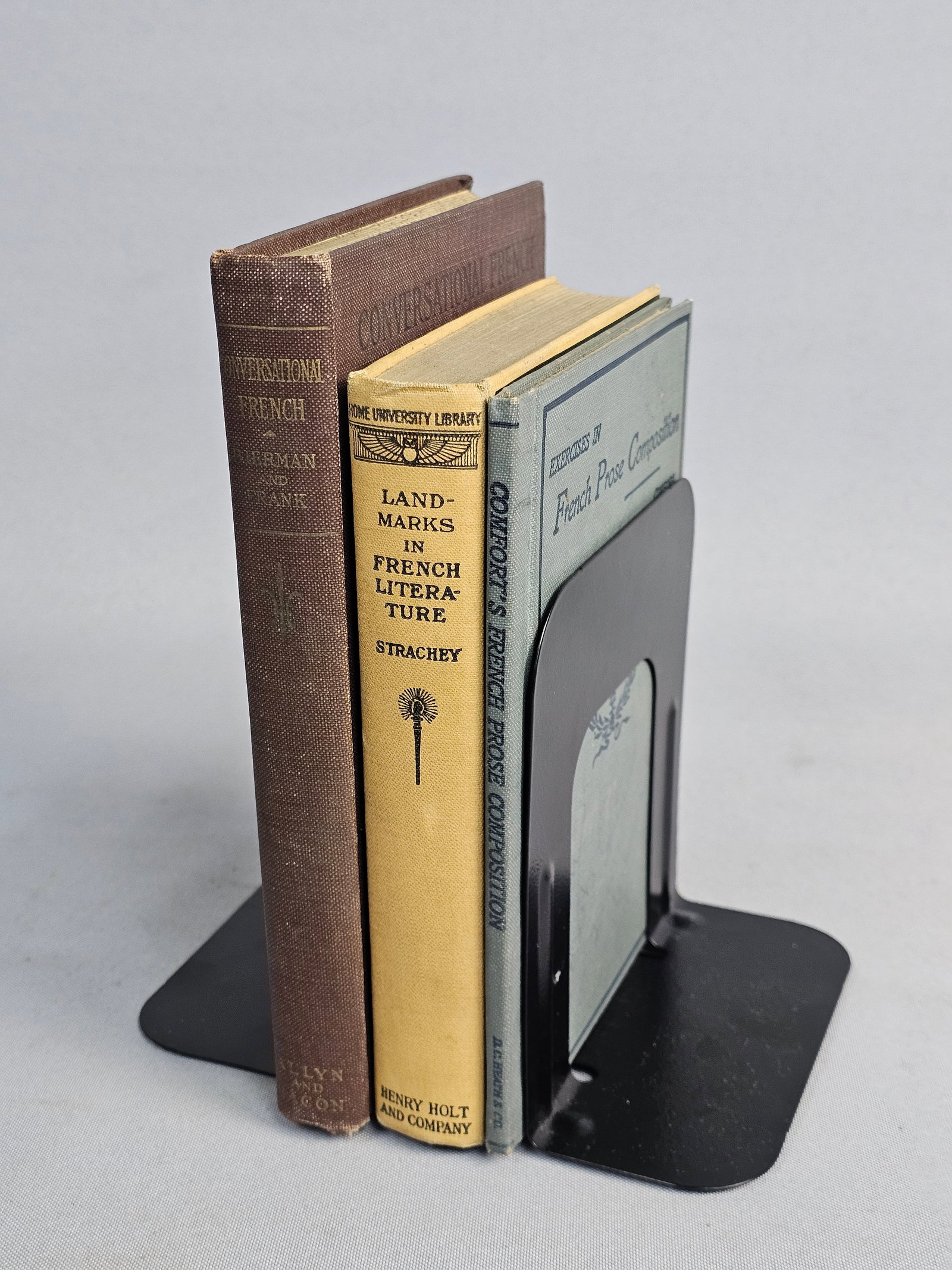 Trio of French Language Volumes: This collection contains three publisher's cloth-bound books from the early 20th century including G. L. Strachey's Landmarks in French Literature (1912) and Bierman and Frank's Conversational French