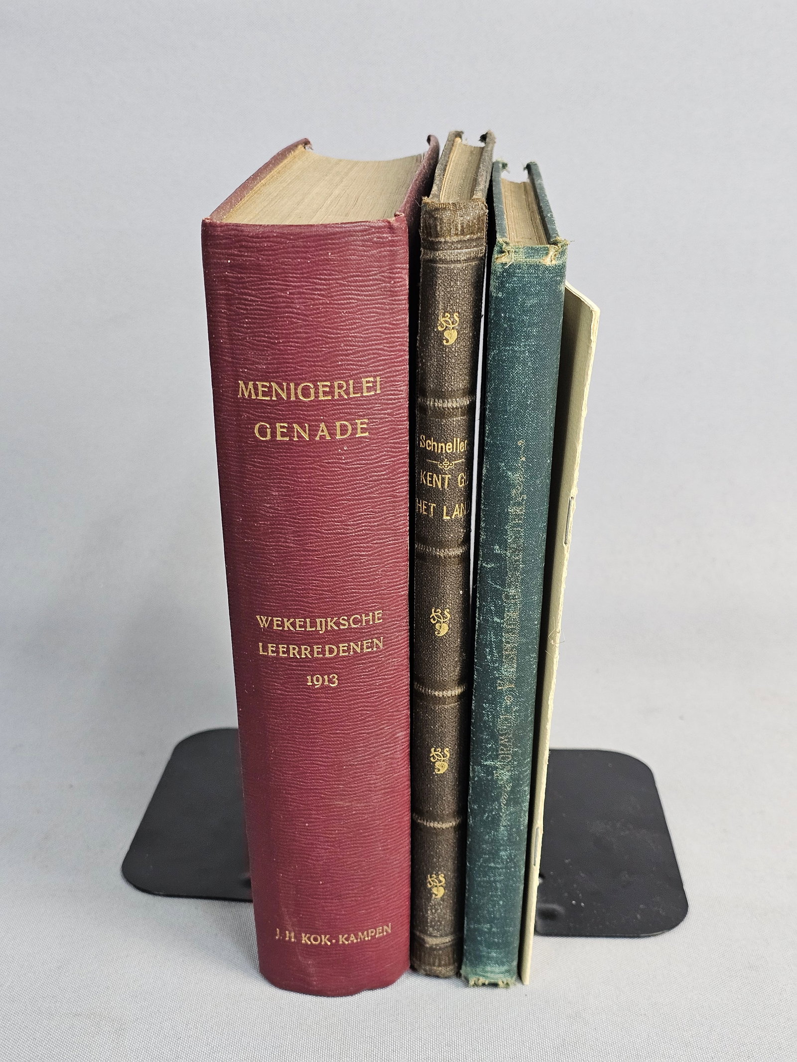 Collection of Dutch Vintage Books: This group consists of several cloth-bound hardcover books and a staple-bound pamphlet, including an 1885 Milwaukee publication by A. Wormser and theological works by Ludwig Schneller. Internal owners