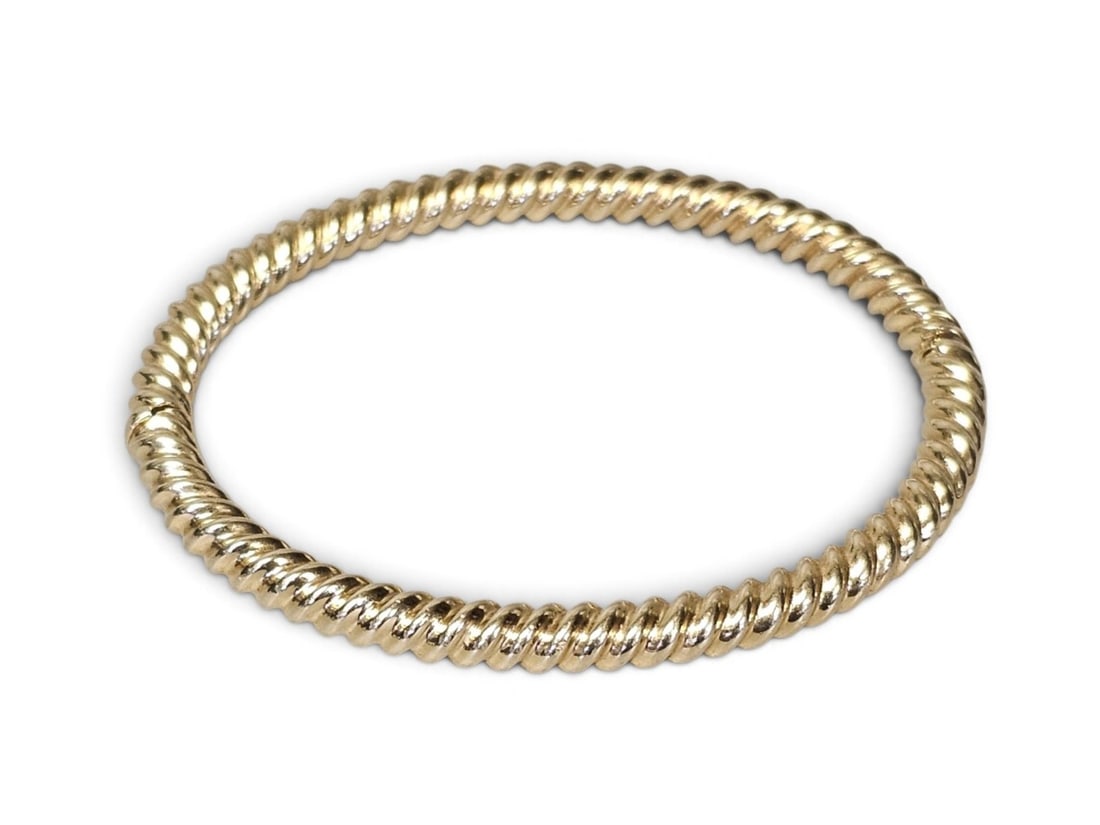 Tiffany & Co. 18K Rope Bangle 18.5 Grams: This vintage Tiffany & Co. bangle is crafted in 18-karat yellow gold and features a classic twisted rope motif. The bracelet is fitted with a concealed hinge and a secure box clasp marked with the "TI
