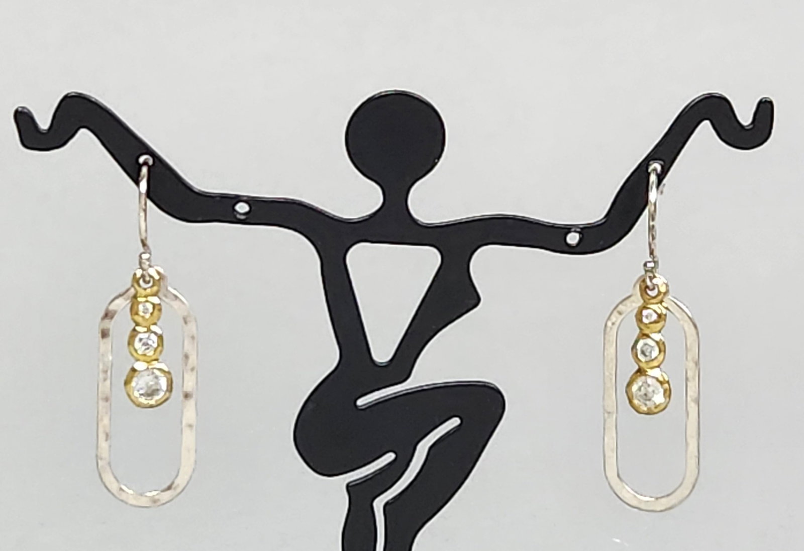 Silpada CZ Earrings 2.73 Grams: A pair of Silpada sterling silver drop earrings featuring three graduated round-cut clear cubic zirconia stones in gold-tone bezel settings & hallmarked 925, CHINA. Total length: 1.1 inches Weight: 2.