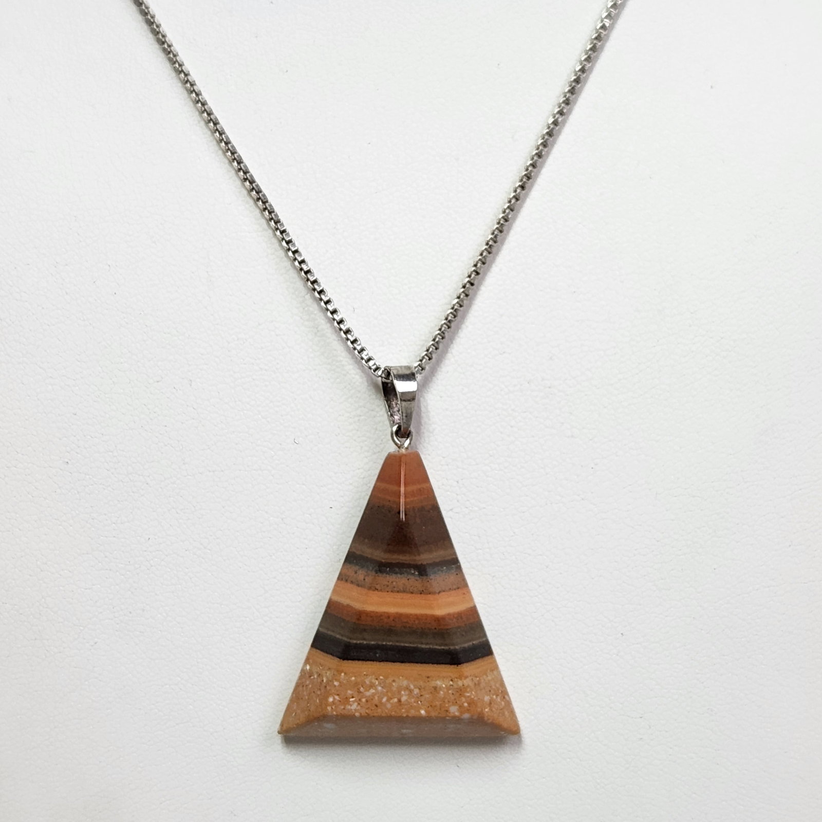 Sterling Pyramid Necklace 5.4 Grams: The pendant is constructed from multi-layered resin or mineral composites. The 20" chain is marked 925 and ITALY and weighs 5.4 grams, while the pendant weighs 10.6 grams. The necklace is in excellent