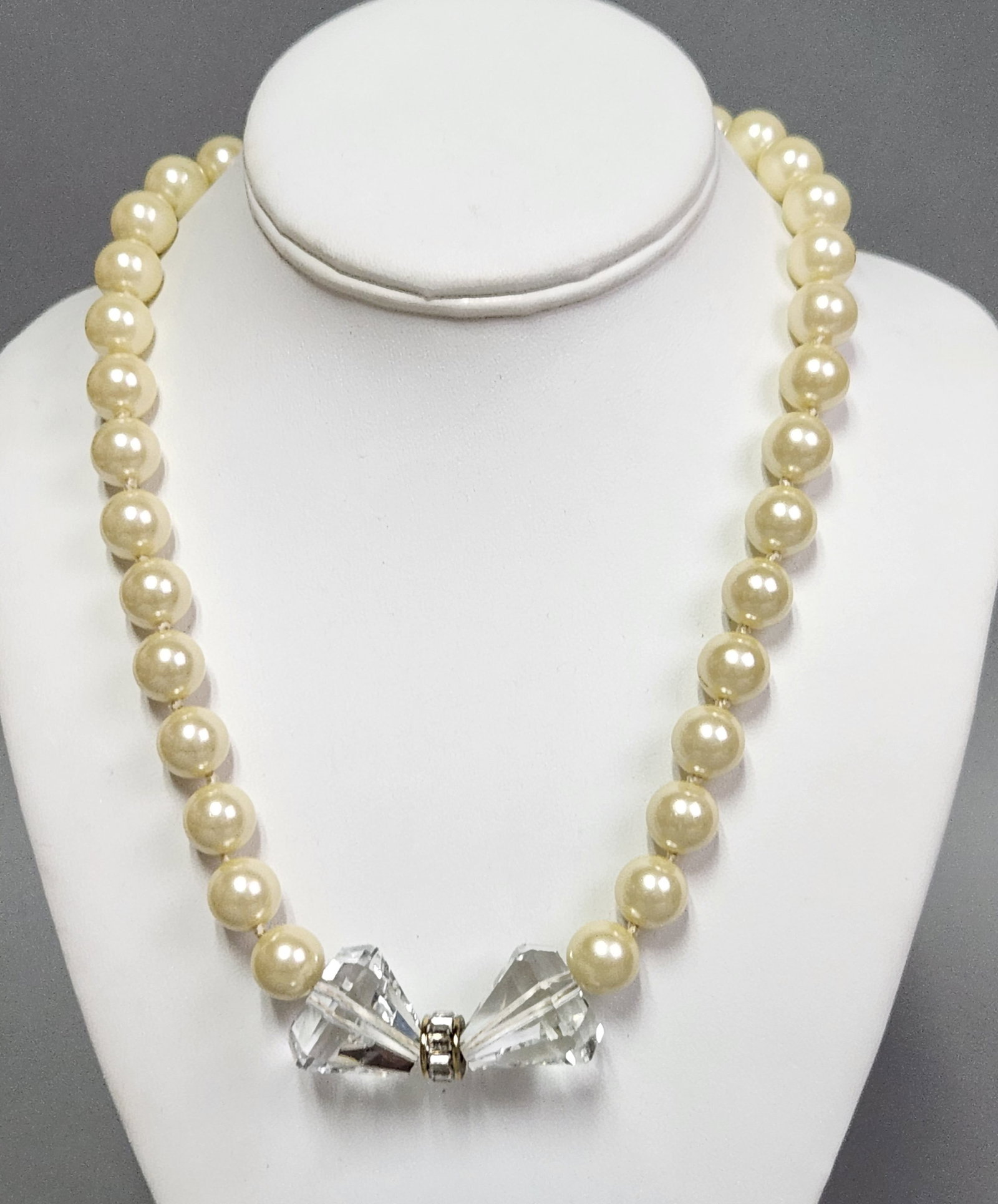 Heidi Daus Disney Convertible Necklace: This Heidi Daus for Disney collaboration modular necklace features three separate strands of cream-colored, individually knotted simulated pearls joined by three gold-tone magnetic barrel clasps accen