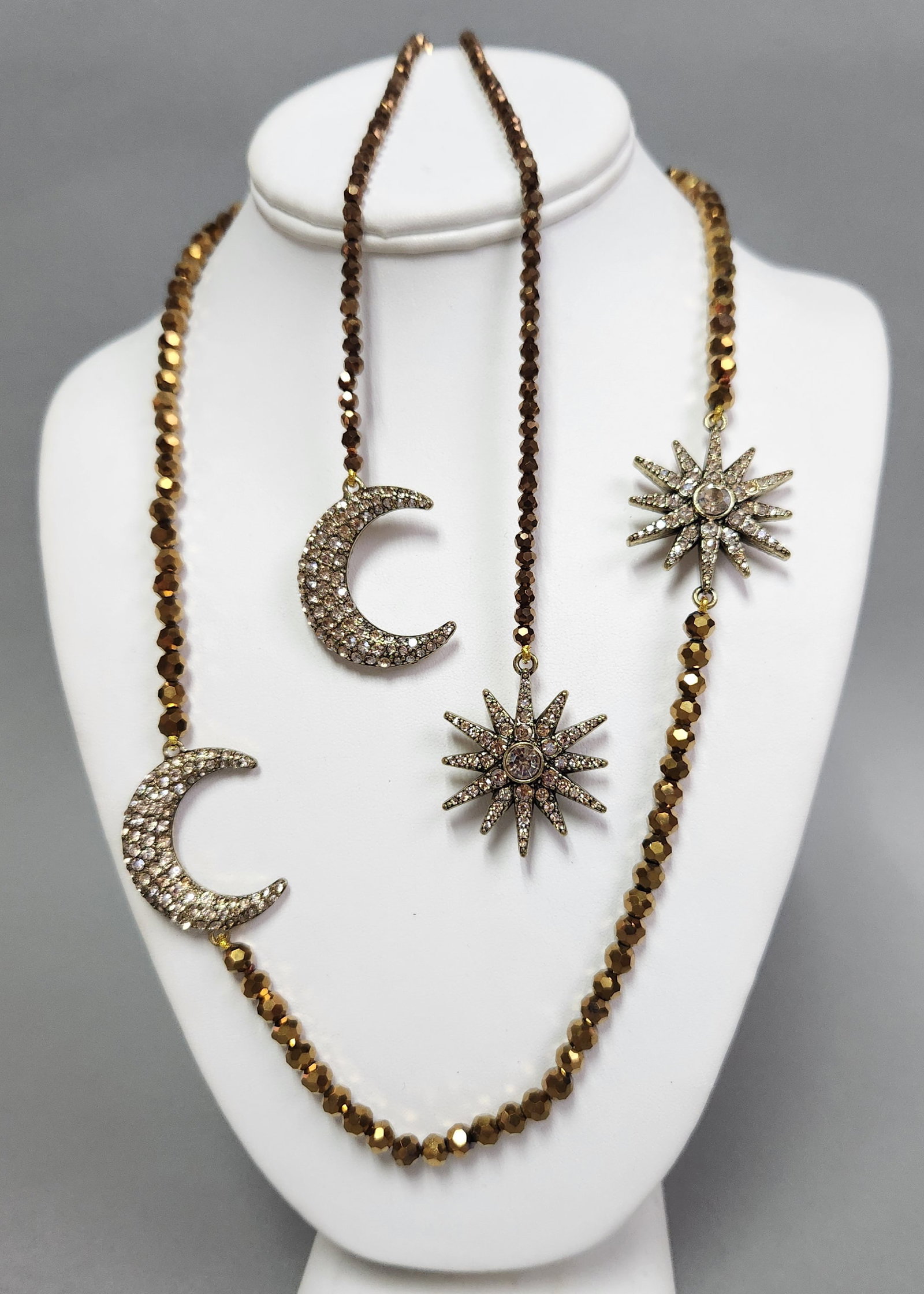 Heidi Daus Celestial Pave Necklace: A Heidi Daus designer necklace featuring faceted bronze-toned beads and large pav?© crystal moon and star charms. The long strand includes a crystal-accented toggle clasp and comes with the original 