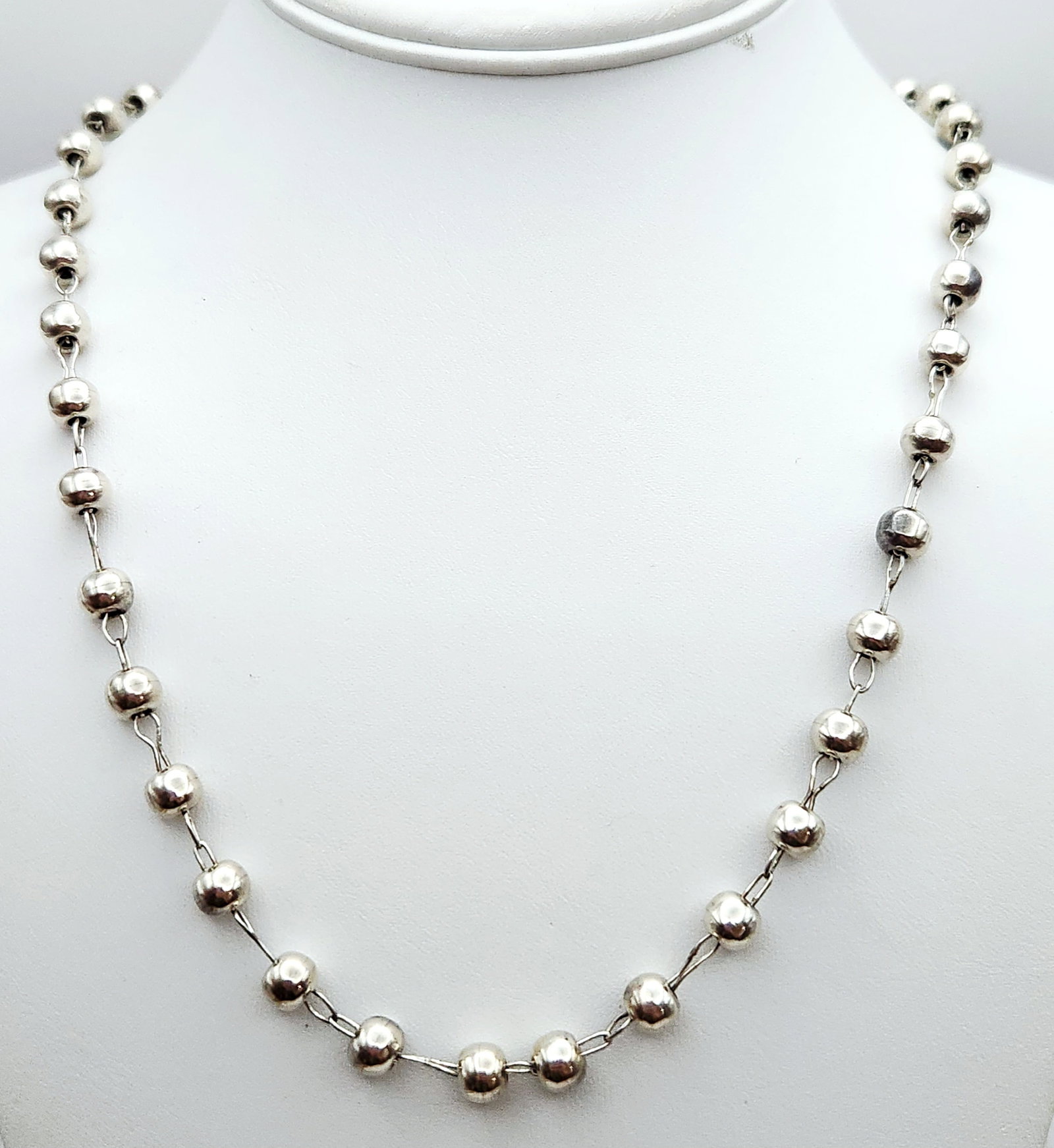 Sterling Beaded Necklace 35.3 Grams: This vintage Taxco Mexican sterling silver necklace features a bead and link design with hollow spheres joined by hand-assembled wire loops. Weight: 35.3 grams Length: 26 inches. The necklace is in go