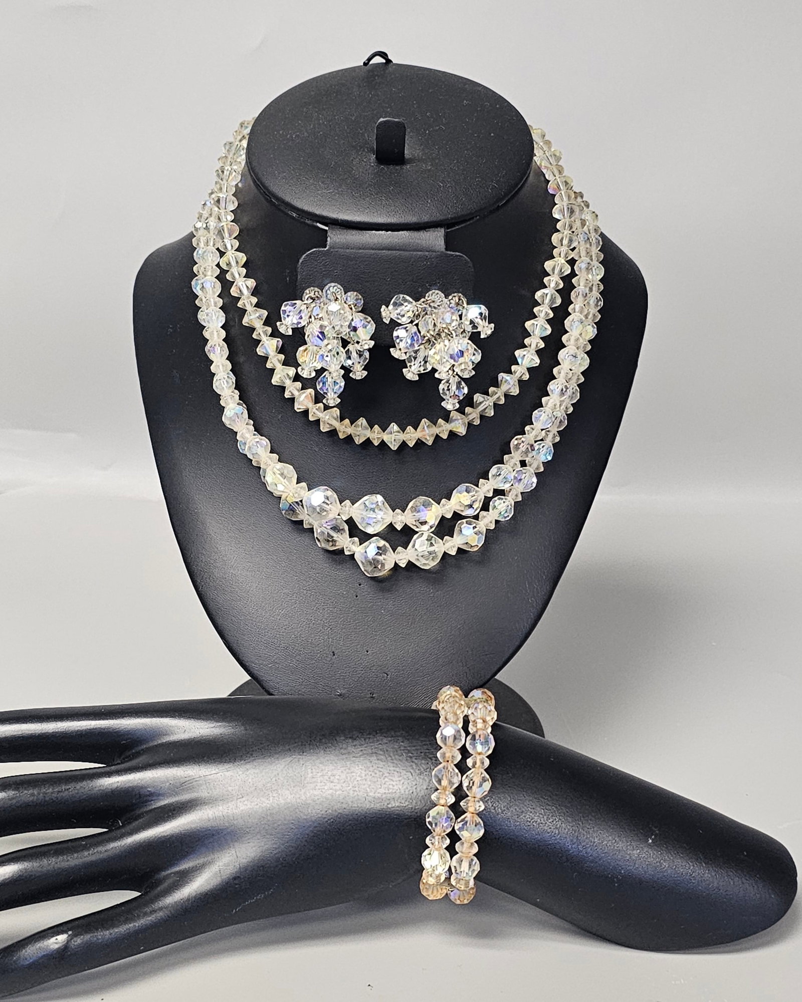 Aurora Borealis Crystal Jewelry Set Inc Laguna: A four-piece vintage jewelry suite by Laguna featuring faceted aurora borealis crystal beads with iridescent reflections. This collection includes 14-inch and 16-inch necklaces, a pair of 1.5-inch clu