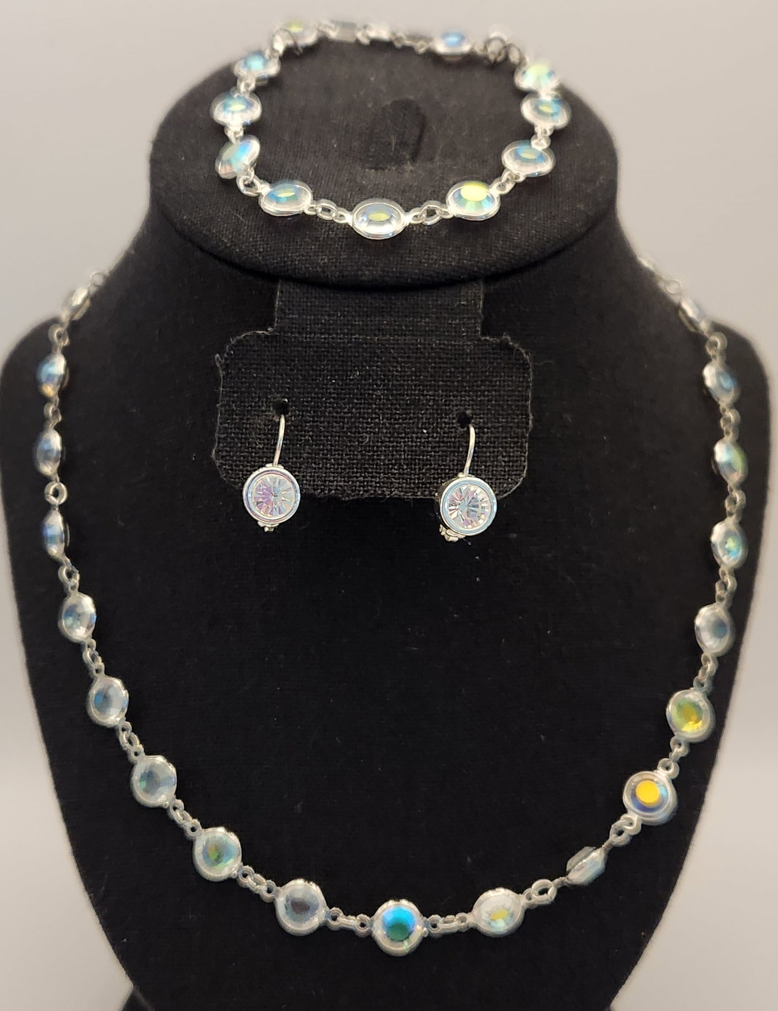 Swarovski Aurora Borealis Jewelry Suite: This three-piece jewelry suite features faceted Swarovski crystals with an iridescent Aurora Borealis finish set in silver-tone bezel settings. Necklace length: 34" Bracelet length: 8 inches Earring