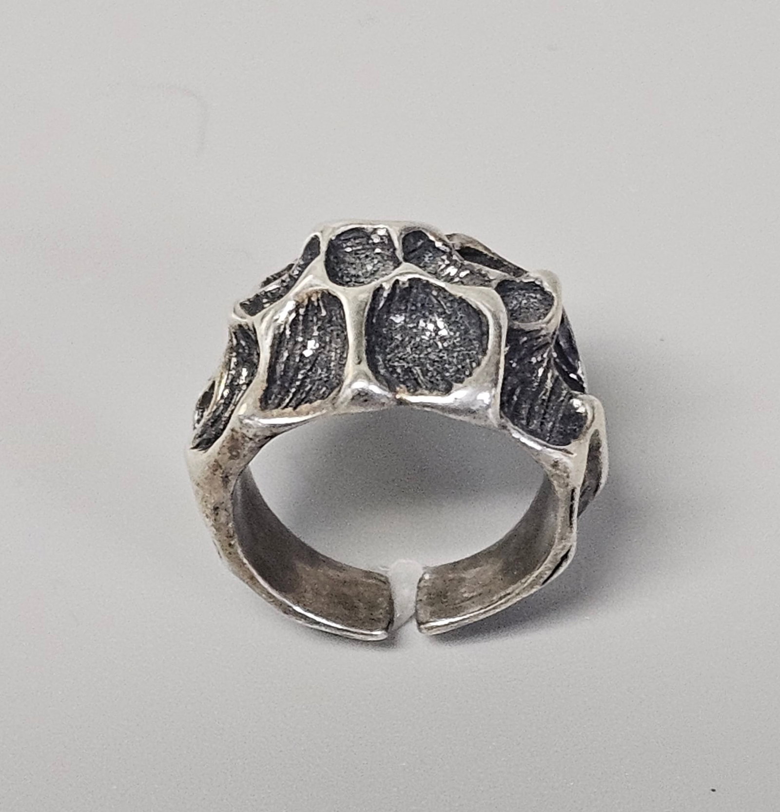 Studio C&K Neptune Sterling Ring 12.0 Grams: Size 6. This solid sterling silver ring features a textured, cast Brutalist design from the Neptune collection by Studio C&K. The interior shank is clearly stamped with the maker mark and collection