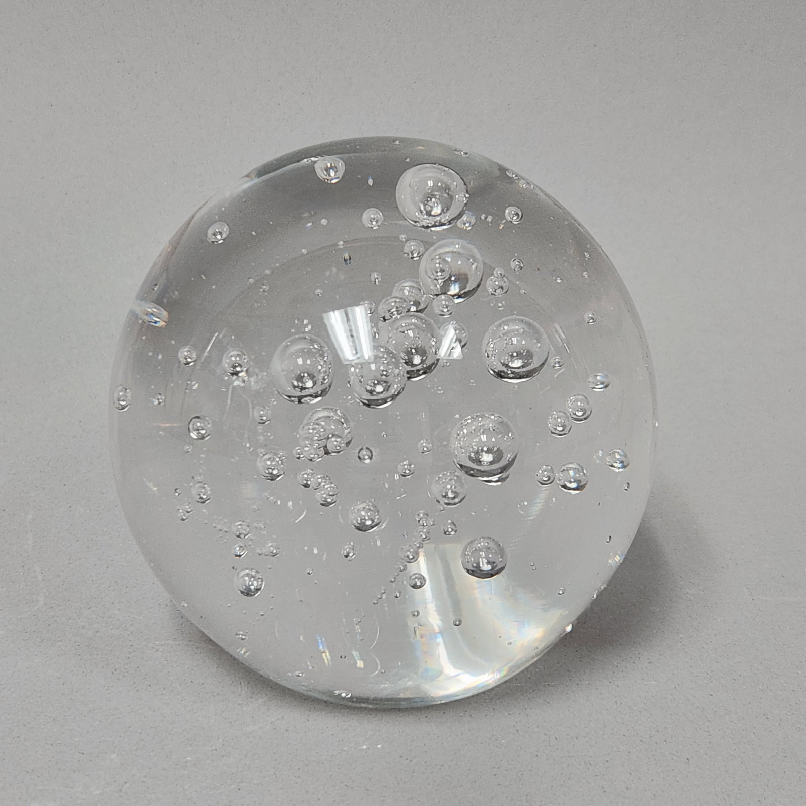 Clear Bubble Glass Paperweight: A spherical clear glass paperweight featuring an internal controlled bubble design. Diameter: 3 inches. The item is in excellent condition with no visible chips, cracks, or internal clouding. Minor su