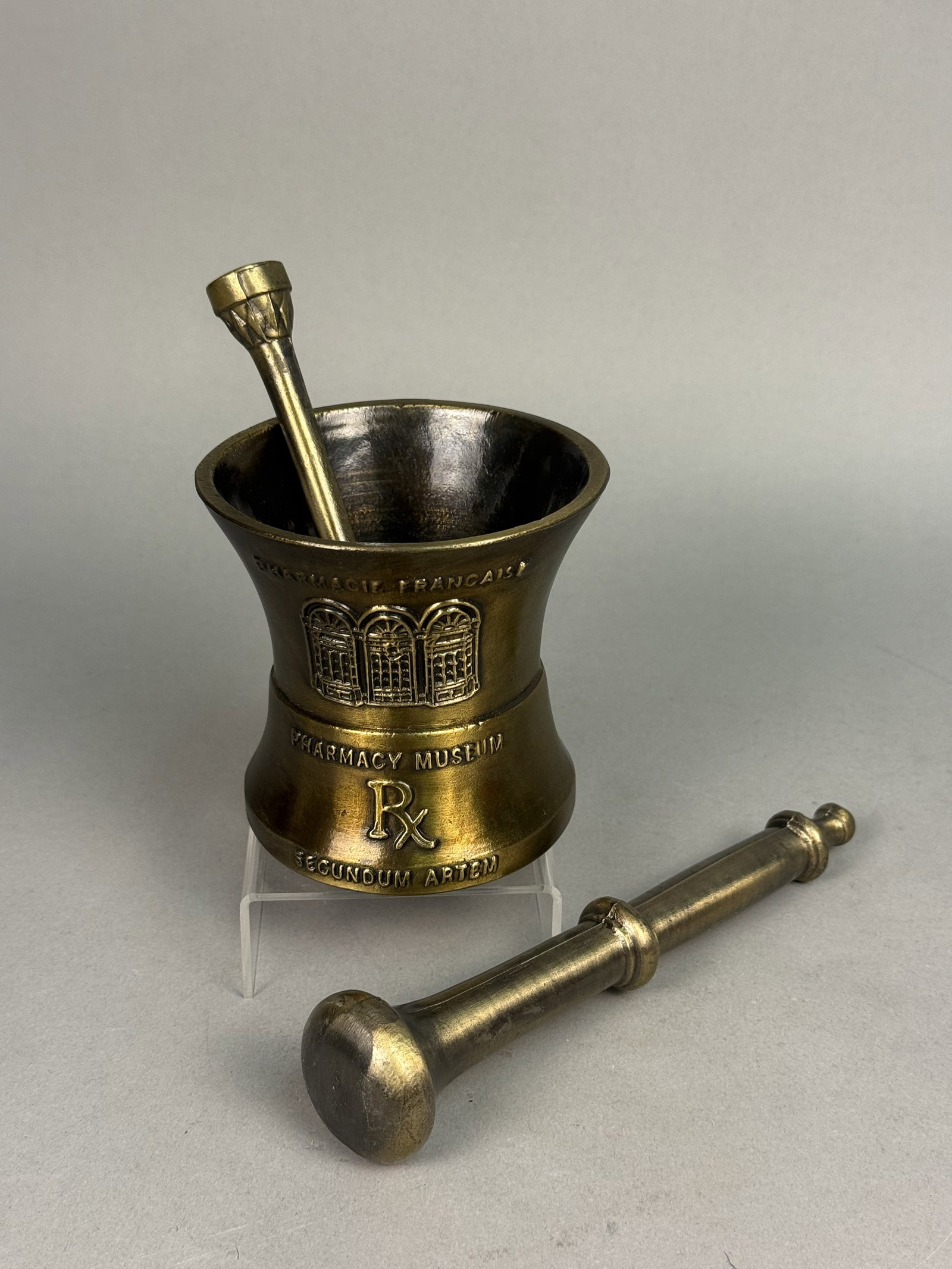 Schering Louis Dufilho Mortar Set: Produced by Schering, this cast brass commemorative set honors Louis J. Dufilho Jr., recognized as America's first licensed practicing pharmacist. The mortar features relief imagery of the New