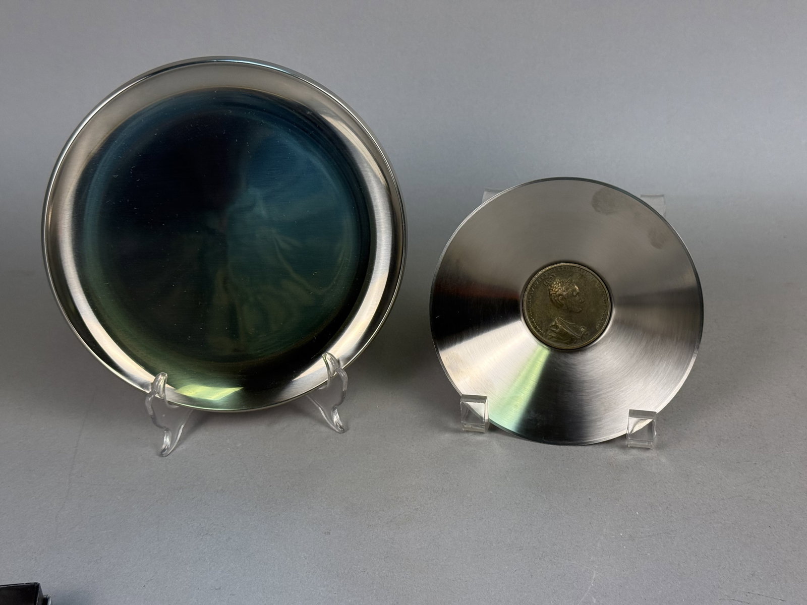 Two Mentholatum Company Stainless Dishes: This pair of Mentholatum Company promotional gifts features a Swedish stainless steel tray and a Florentine coin bowl. The tray is marked 18-8 Sweden and features the engraved company name, while the