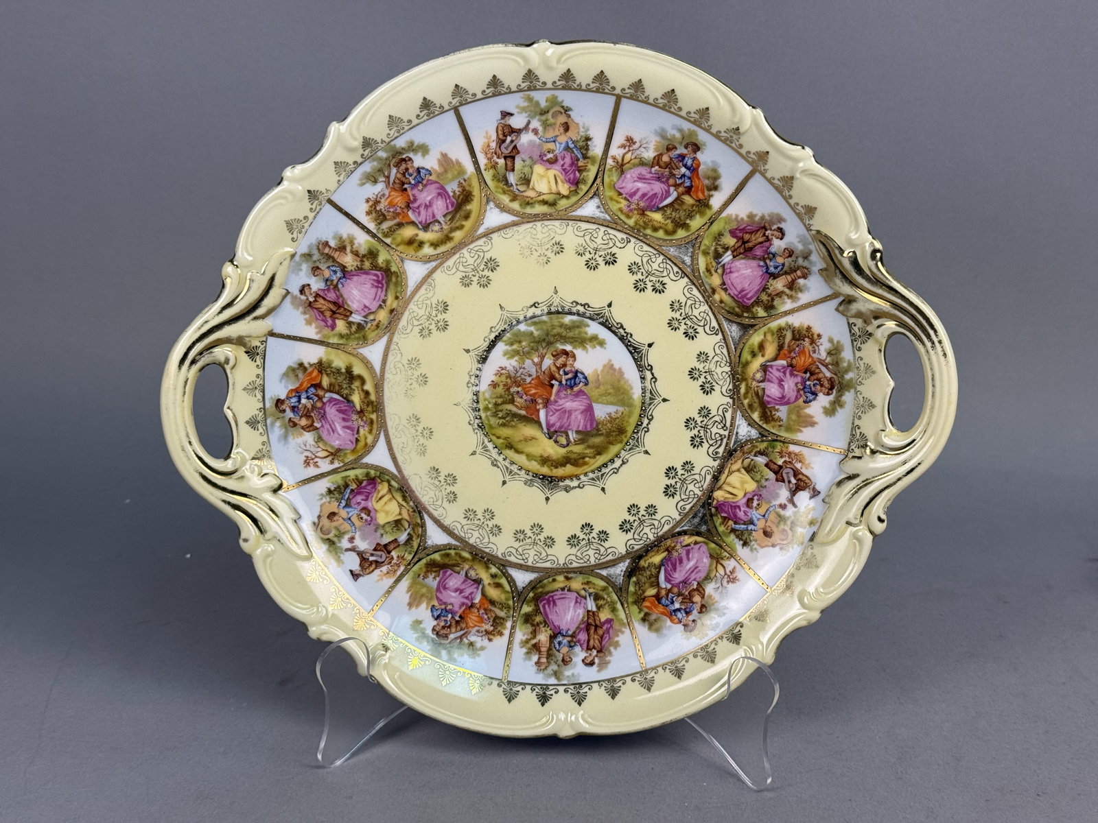 Hutschenreuther Love Story Porcelain Tray: A Hutschenreuther porcelain handled tray in the Love Story pattern, manufactured in Bavaria, West Germany. The piece features a pale yellow ground decorated with romantic Fragonard scenes and