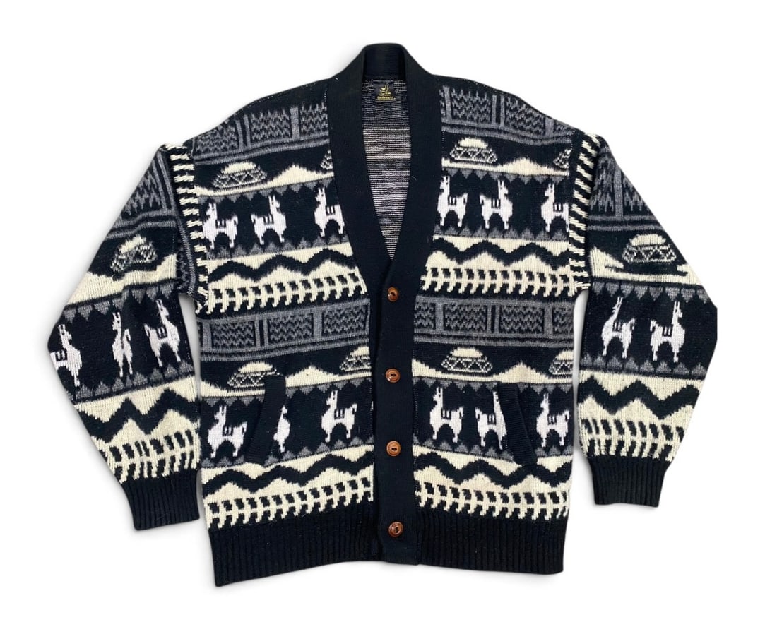 Vintage Tejidos Centenario Llama Cardigan: This Tejidos Centenario cardigan is hand-knit in Otavalo, Ecuador, from a soft wool and angora blend. The garment features a traditional monochromatic Andean motif with repeating llama figures, geomet