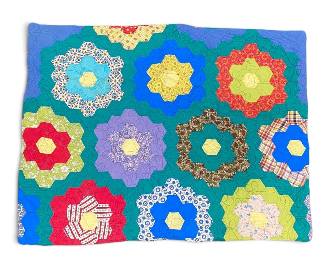 Grandmother's Flower Garden Quilted Sham: This hand-pieced and hand-quilted pillow sham features the traditional Grandmothers Flower Garden pattern composed of various mid-century cotton prints set against a solid teal-green ground. The