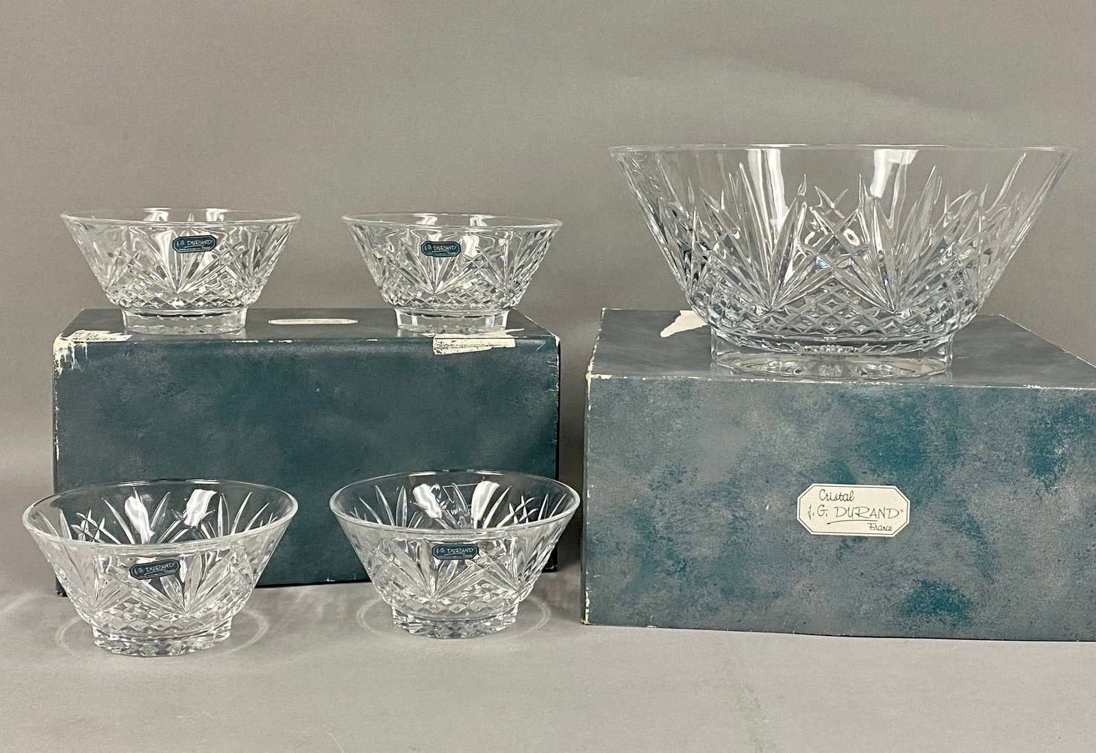J.G. Durand Villemont Crystal Bowl Set: A set of five J.G. Durand lead crystal serving bowls in the Villemont pattern. The collection includes one large master bowl and four individual bowls, each featuring deep fan-shaped cuts above a