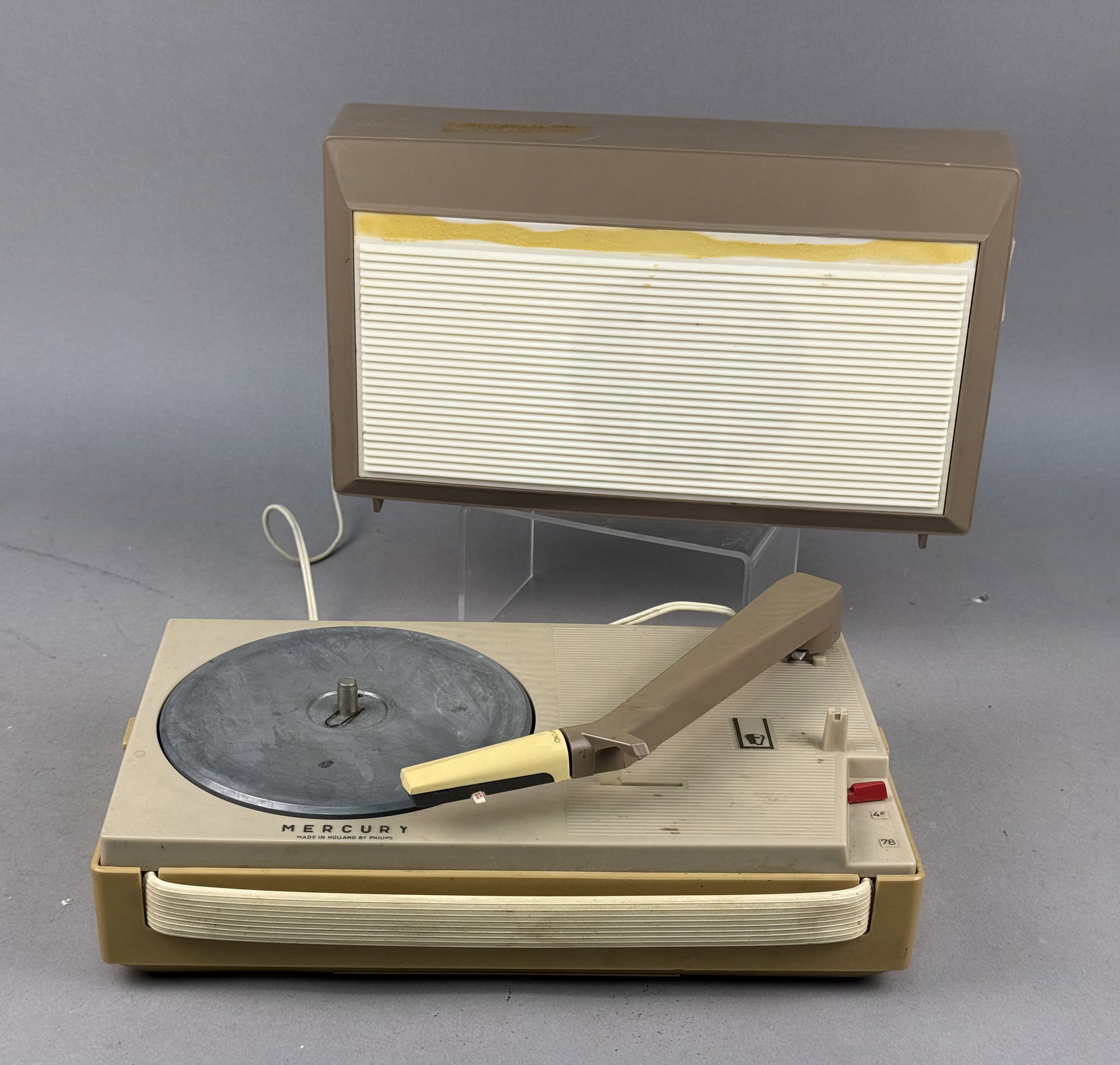 Philips Mercury AG 4000/54 Portable Phonograph: Philips Mercury model AG 4000/54 all-transistor portable record player in a two-tone plastic cabinet. Manufactured in Holland, the unit features a three-speed selector for 33, 45, and 78 RPM playback 