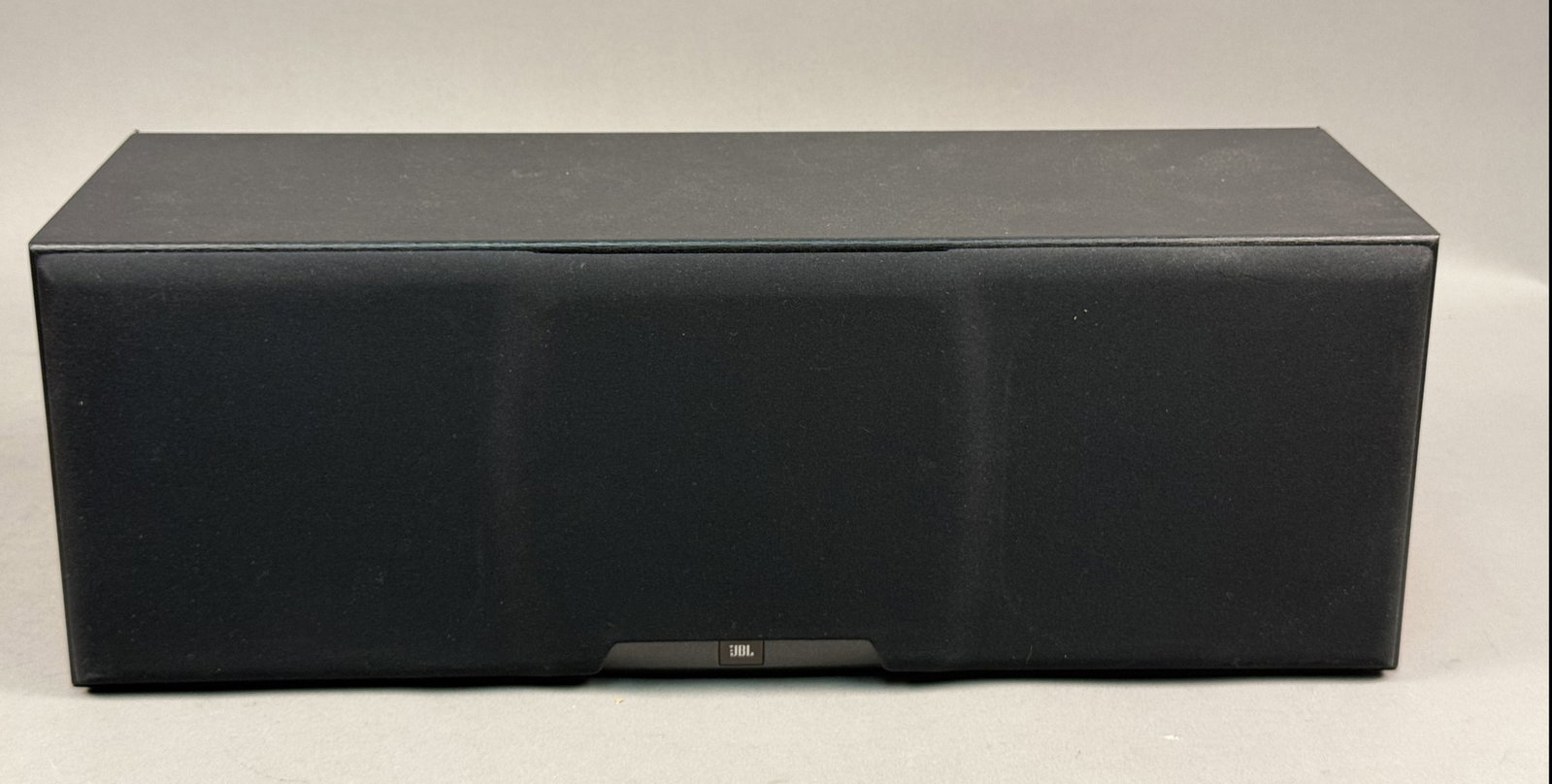 JBL HLS Center Channel Speaker: The JBL HLS Center channel speaker is a two-way system featuring dual woofers and a central horn-loaded tweeter. Manufactured in the USA, the unit is finished in black woodgrain vinyl and includes a