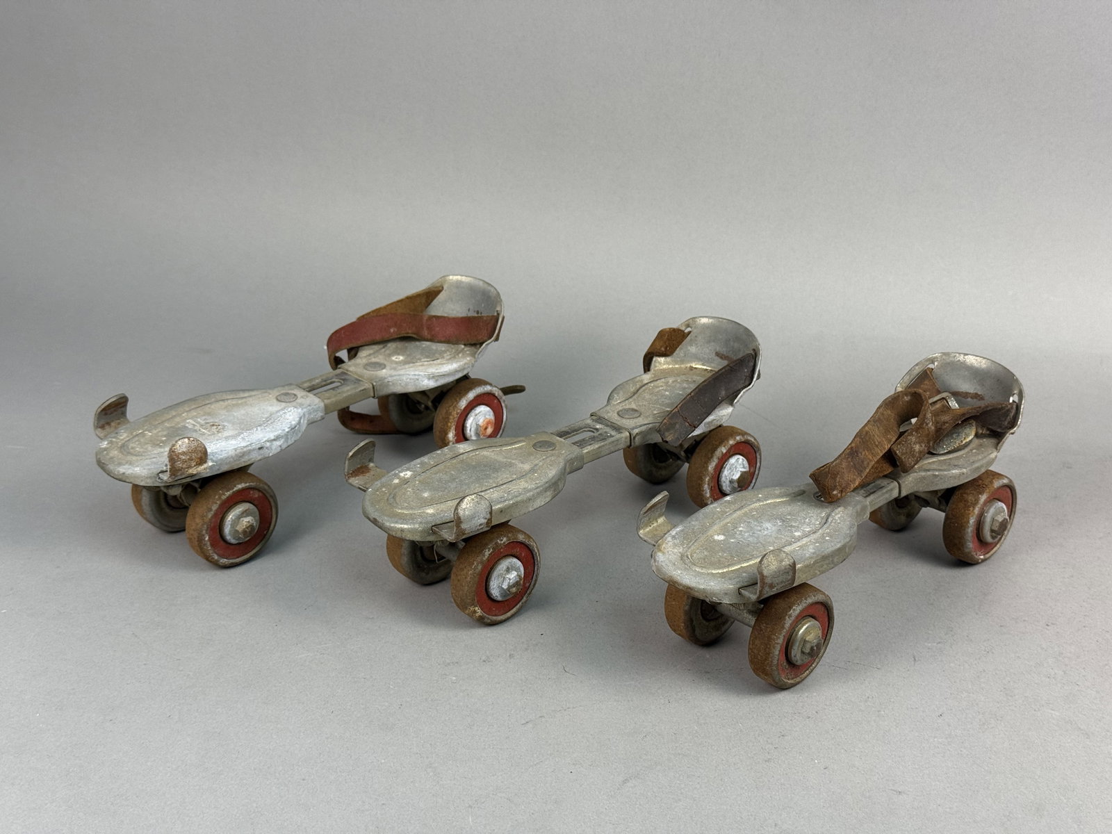 Three Union Hardware Roller Skates: These adjustable steel sidewalk roller skates were manufactured by the Union Hardware Company. The group consists of three individual units featuring screw-tightened toe clamps and remnants of