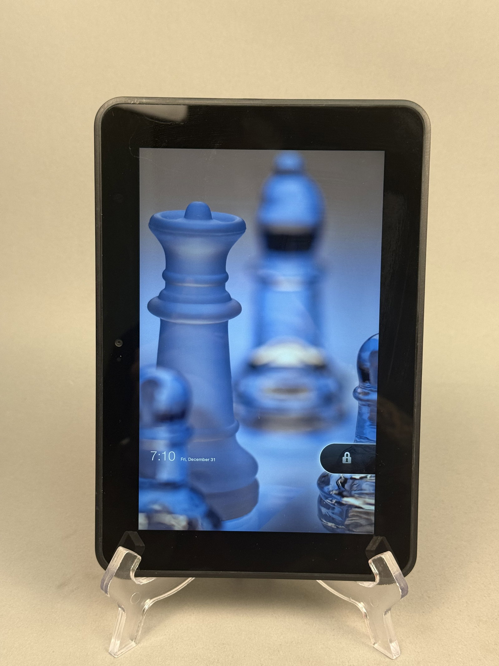Amazon Kindle Fire 1st Generation Tablet: This Amazon Kindle Fire 1st Generation tablet features a black bezel surrounding a 7-inch color touchscreen and a dark charcoal soft-touch rear panel. The back of the device is marked with the Amazon 